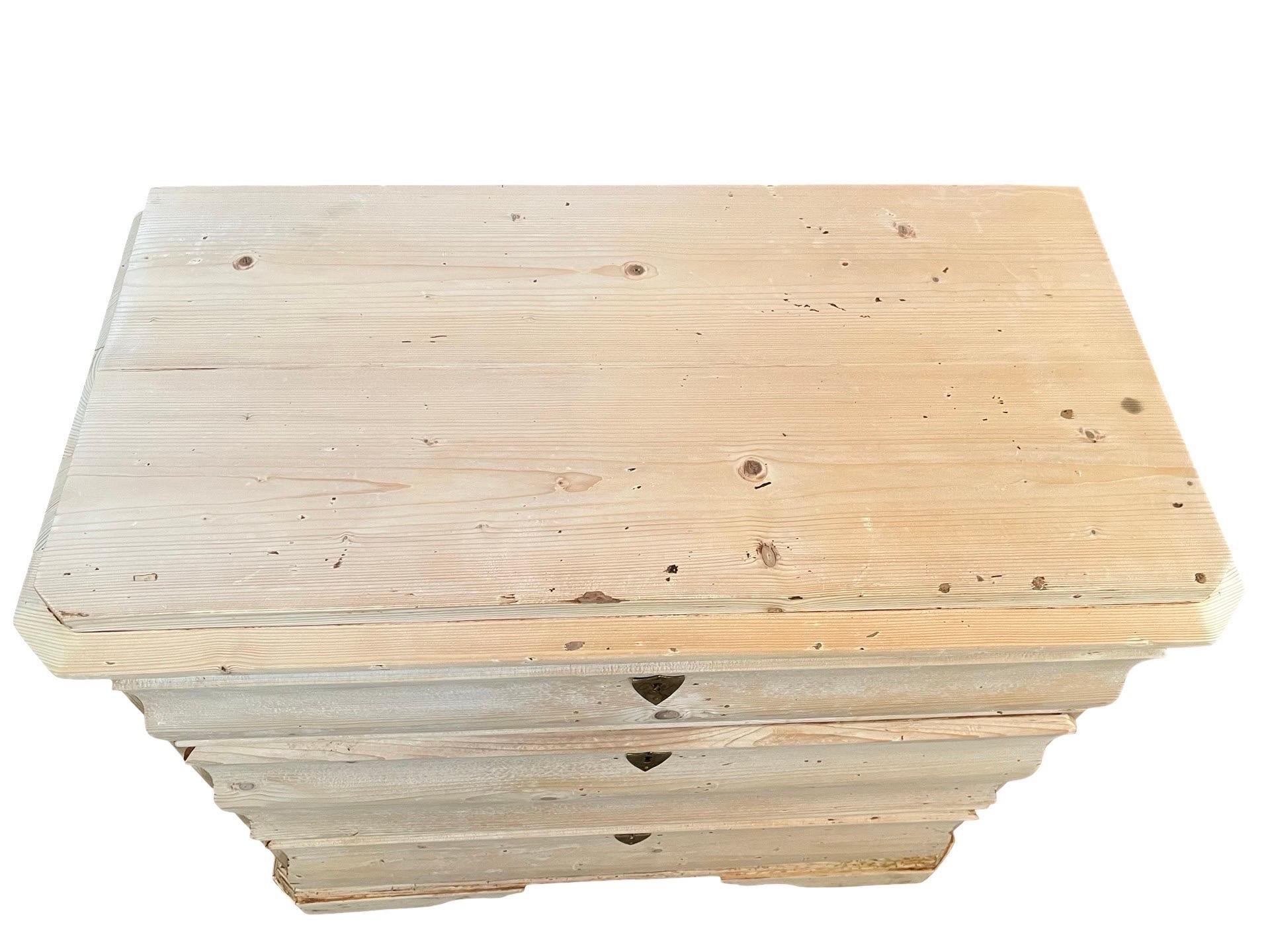 Biedermeier chest of drawers hand-crafted in Denmark in the early 1800s using pine. The chest features three overlay drawers with beautiful, hand-made dovetail joints and curved drawer fronts. The side are flat and the top is flat and framed by