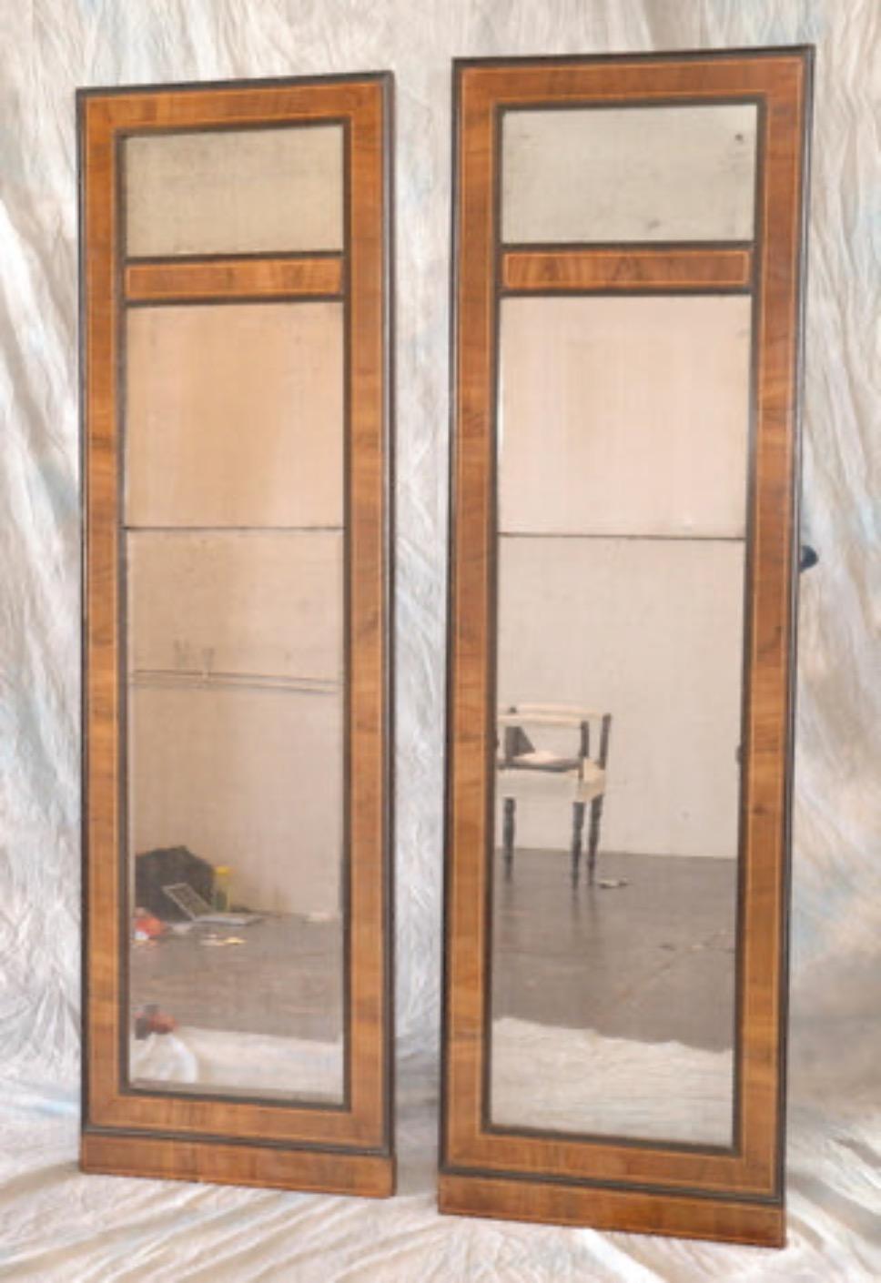Paire de miroirs danois du début du XIXe siècle de style Empire, avec cadre en bois de noyer et verre d'origine. Avec ses fines garnitures noires en ébénisterie et ses panneaux architecturaux simples, la paire a un aspect de fenêtre moderne mais