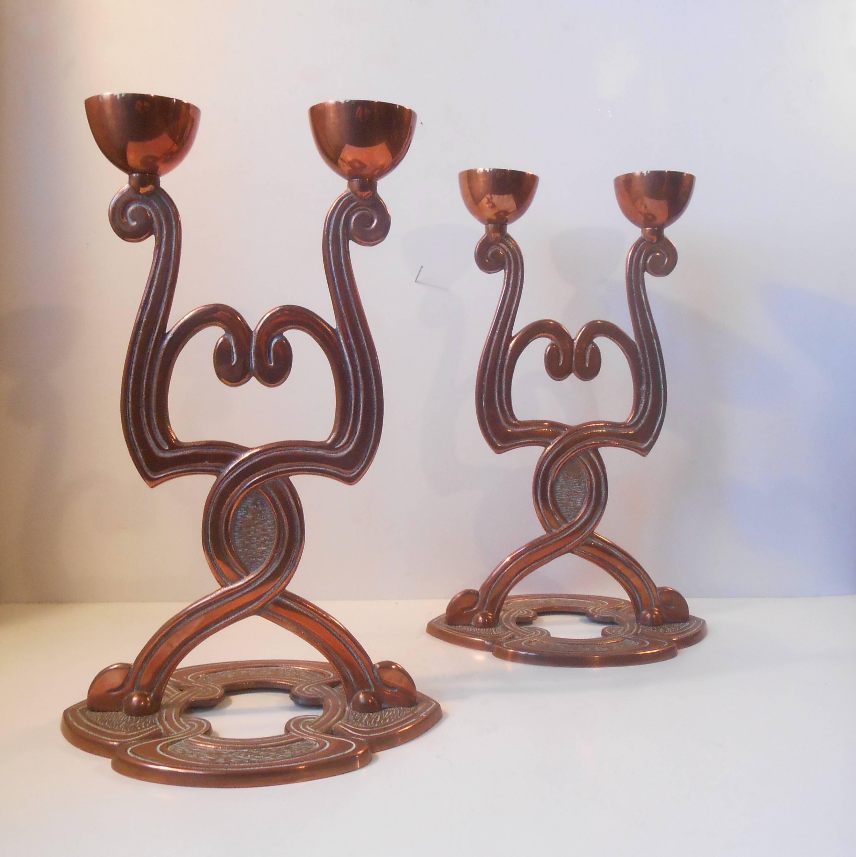 Exquisite period detailing on this pair of copper twin - candleholders. Typical elongated organic shapes with smooth curves and age consistent patina. The style is reminiscent to Thorvald Bindesboll. Height 13.5 inches. The price is for the pair.