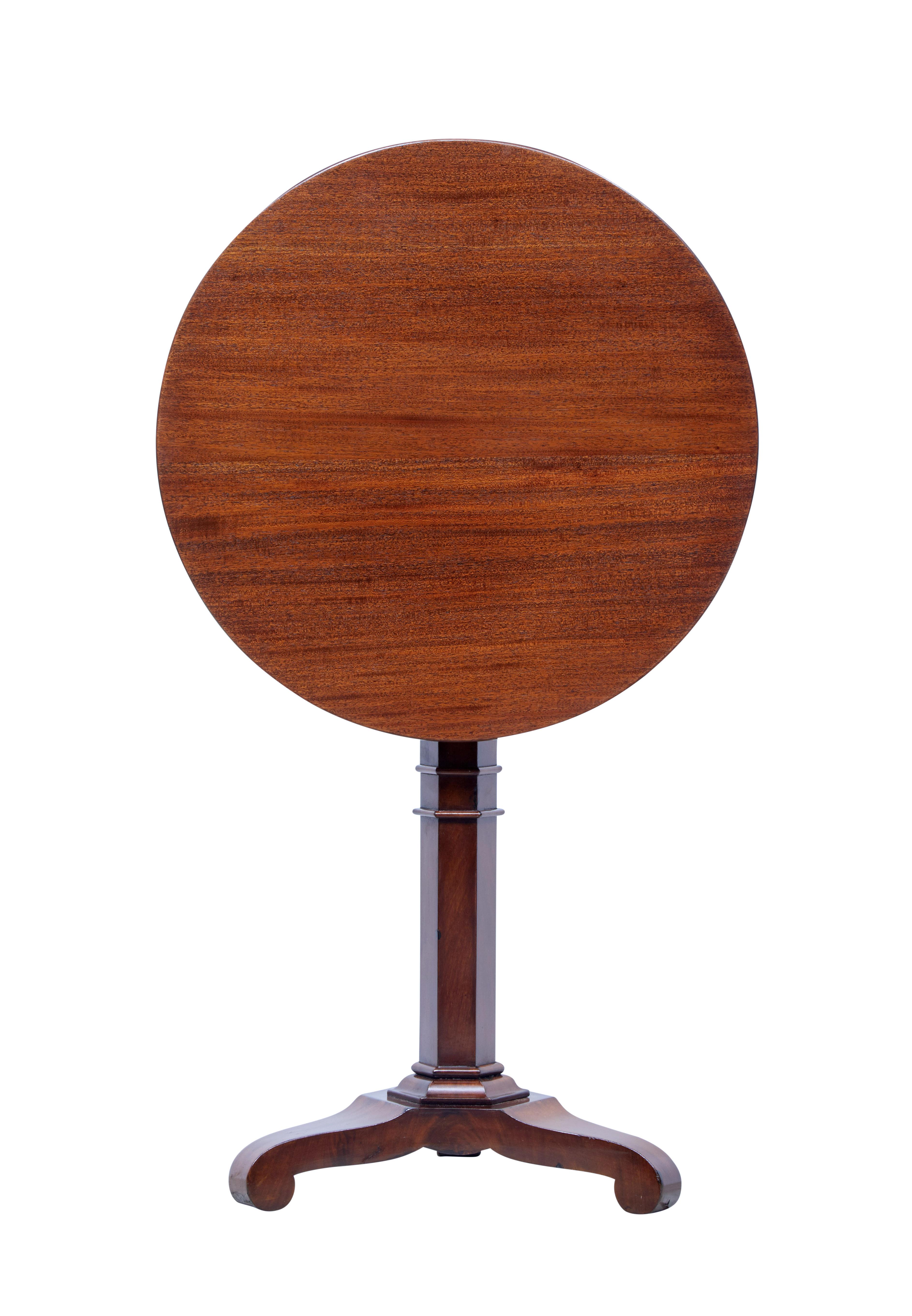 Elegant round Danish mahogany occasional table, circa 1850.

Re-polished circular top, tilting top which is secured by peg. Supported by hexagonal stem and standing on triform base with scrolled feet.

Minor surface marks.