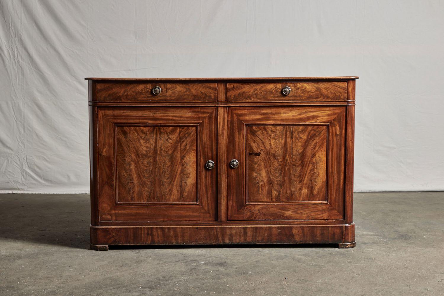Late 19th century sideboard made of fine quality Honduras mahogany. It features a finely figured top and two drawers above two paneled drawers.