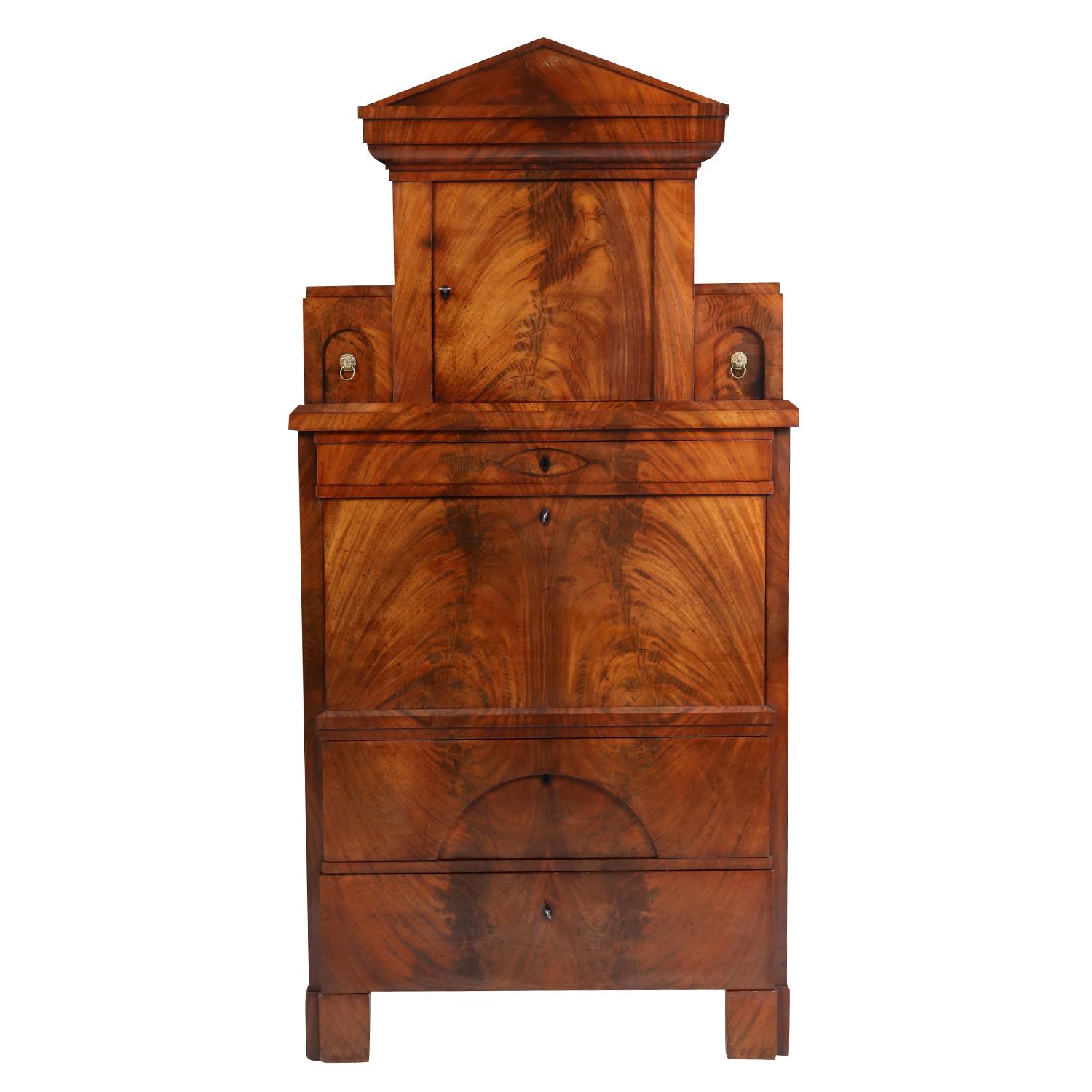 A dark-brown, antique German Biedermeier two-part cabinet with a writing flap made of handcrafted veneered Mahogany, in good condition. The bottom part of the shellac polished secretary is composed with two large drawers, standing on four wide