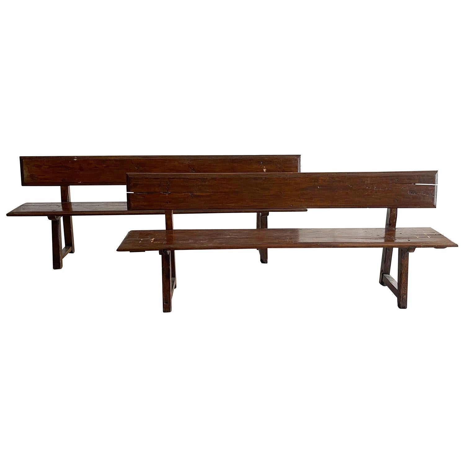 An antique pair of Italian chestnut benches with backrest, and trestles on the foot bases. Minimalist shape in very good condition. One is slightly larger than the other. Wear consistent with age and use. Circa 1830 Piedmont, Italy.

Measures: