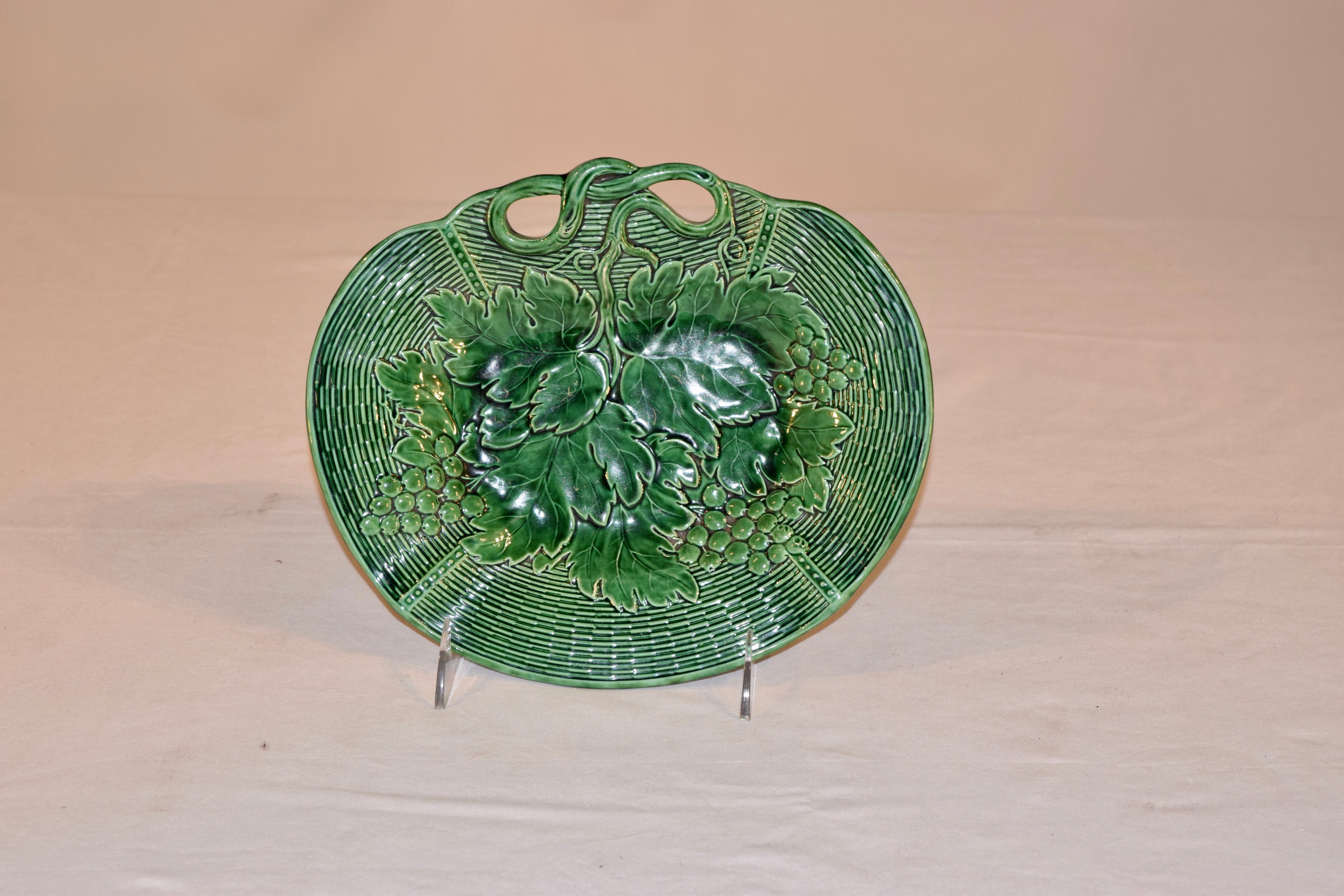 19th century signed Davenport majolica dish in vibrant green. The handle of the dish are molded to look like vines and the rim in a woven basket patter, with a central design of leaves and grapes. Excellent crisp pressing of the mold.