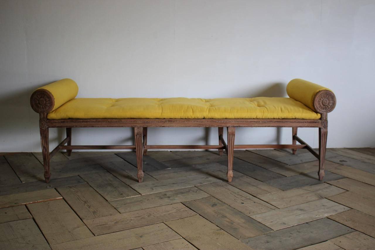 A very elegant, 19th century eight legged window seat / daybed in the classical taste, in bleached beech, retaining the original cane in the seat, having been upholstered by us in a hand dyed antique linen in bright yellow, that will make a