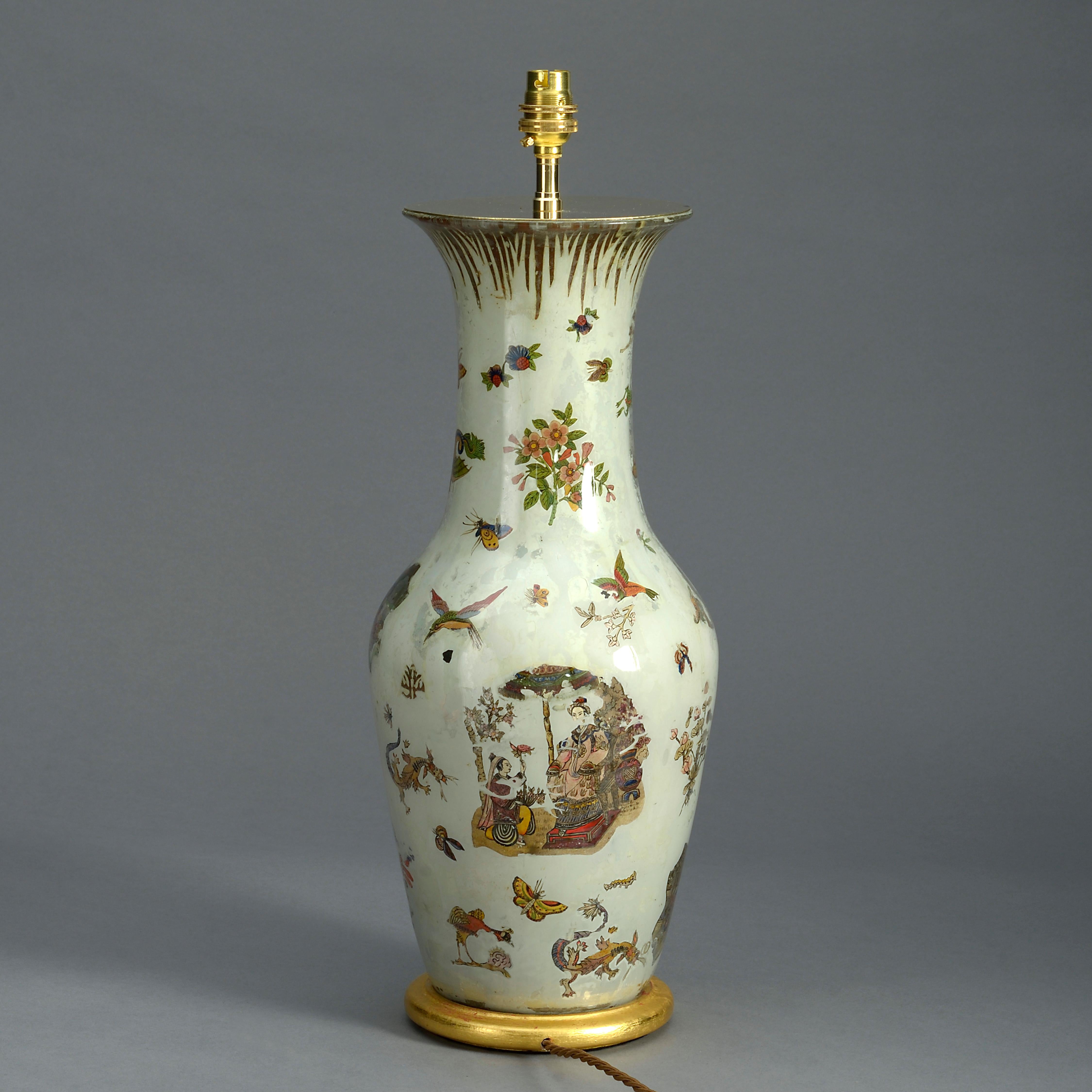 A mid-nineteenth century Decalcomania glass vase, of baluster form, the body decorated throughout with dragons, chinamen, flowers, birds, insects, and other chinoiseries on an ivory ground, all raised on a turned giltwood base and mounted as a