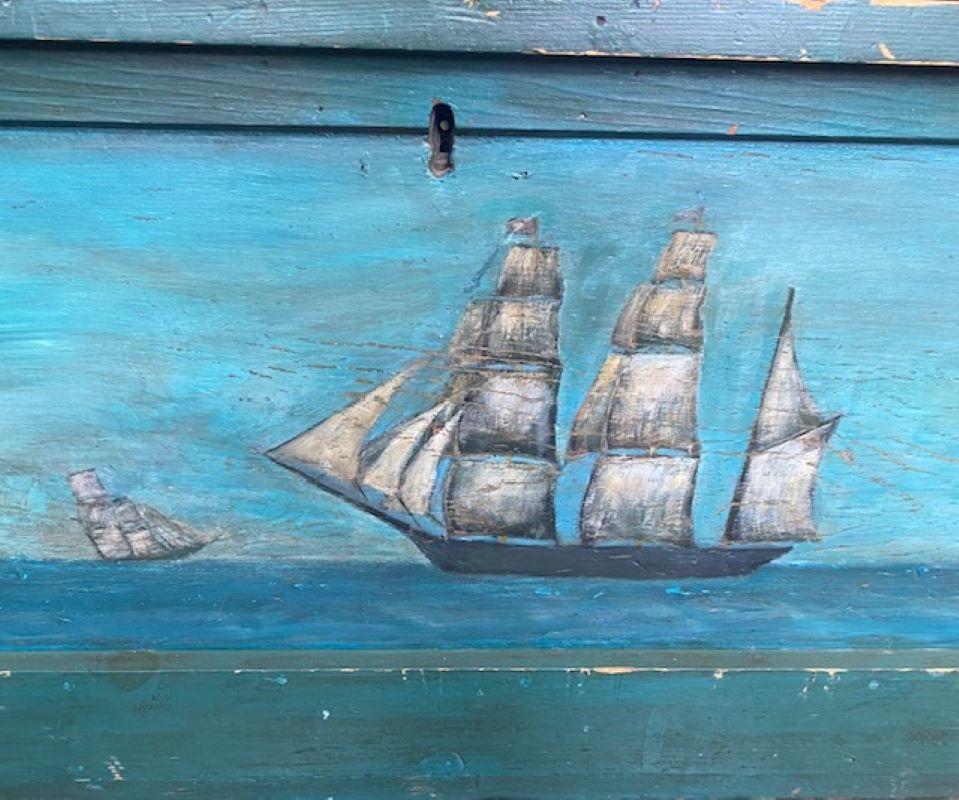 19th Century Decorated Sea Chest, having a hinged lid with breadboard edges, above a dovetailed case with applied molding around base, the original wooden beckets with relief carved and gilded stars and sailor's spliced rope handles, in old green