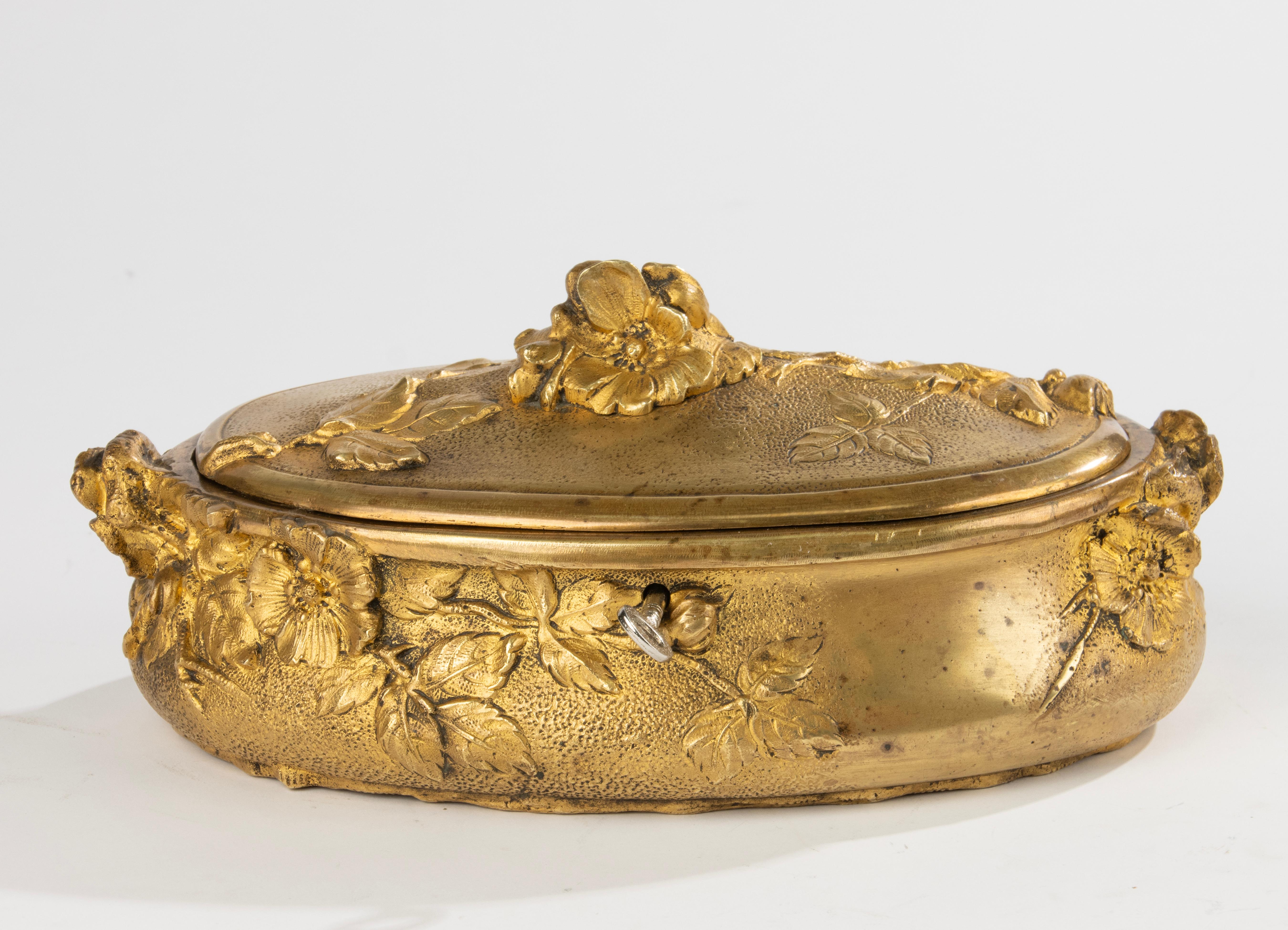 A refined Napoleon III period decorative box, made of ormolu gilt casted bronze. Richly ornate floral motifs. It has an illegible signature. The liner inside has been renewed. Including a key with a working lock (the key is not original to the box).