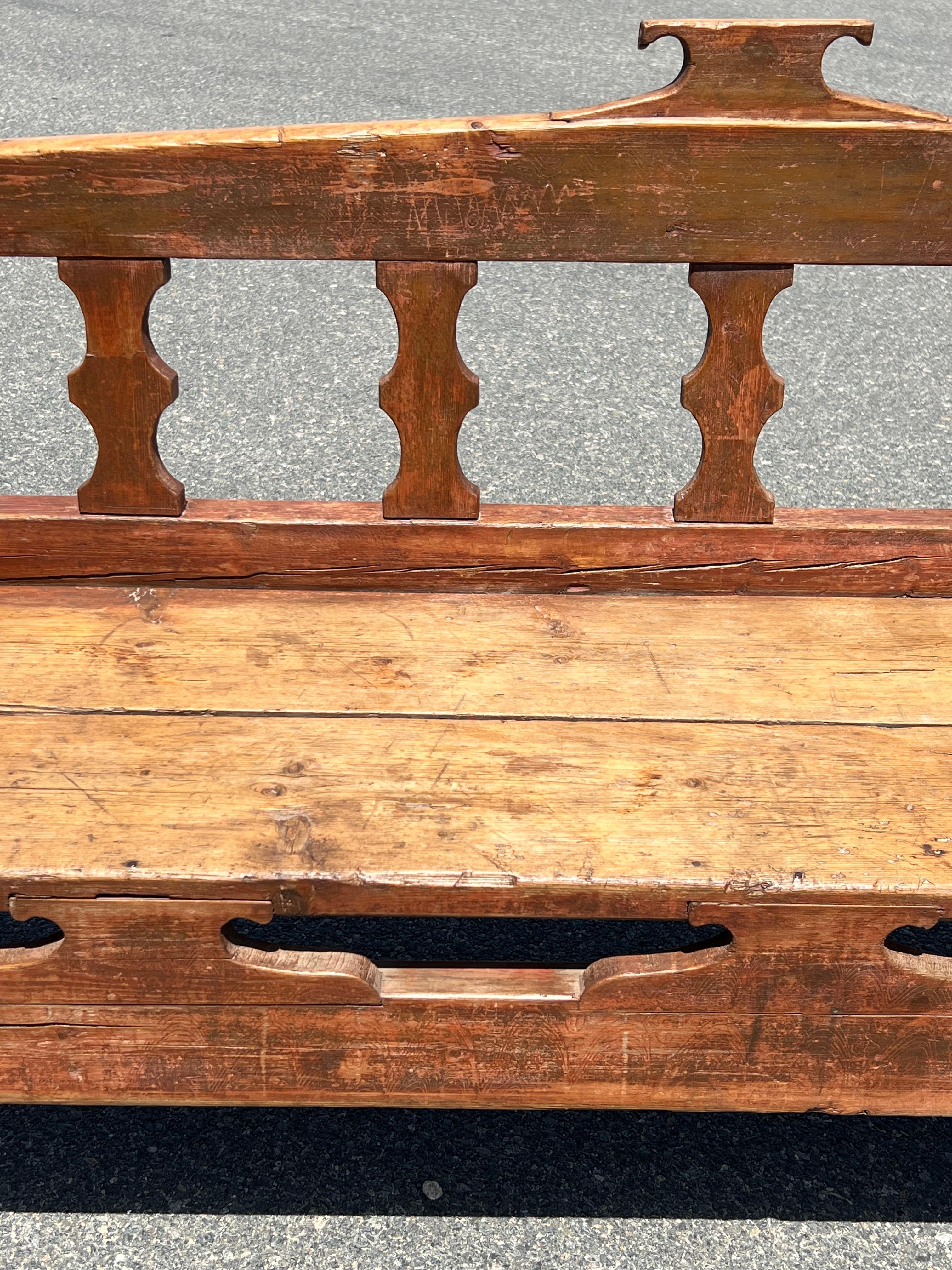 North American 19th Century Decoratively Carved Bench in Original Pink and Red Paint For Sale