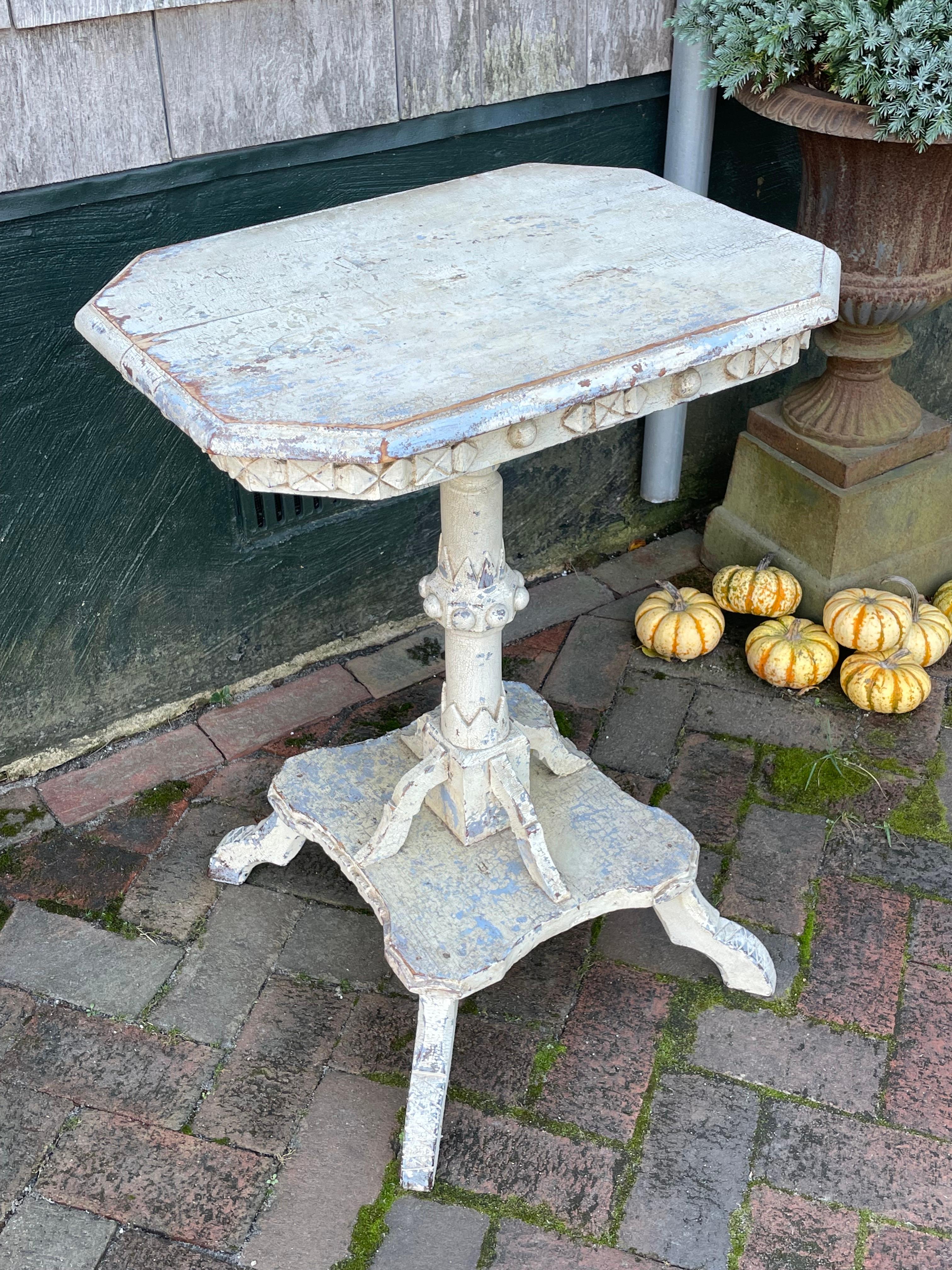 19th century Candle Stand in original white over light blue/grey paint, with all-over crazed surface.  Extensive decorative carvings on apron and pedestal base.  Quebec, circa 1880.