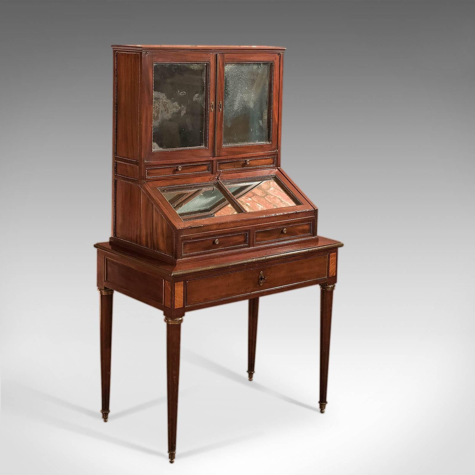 This is a French antique bonheur du jour by Jean-Baptiste Gamichon dating to circa 1810.

A piece for the connoisseur, rare and sought after, this exquisite cabinet is offered to the market in an original and gloriously unrestored