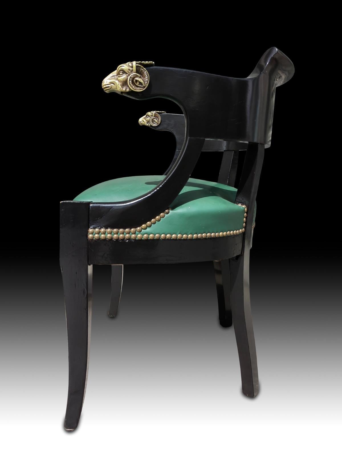 XIX century desk chair. Pretty xix century armchair ebonized and upholstered in green leather. The armrests have 2 chiselled bronze ram's head.
good condition.