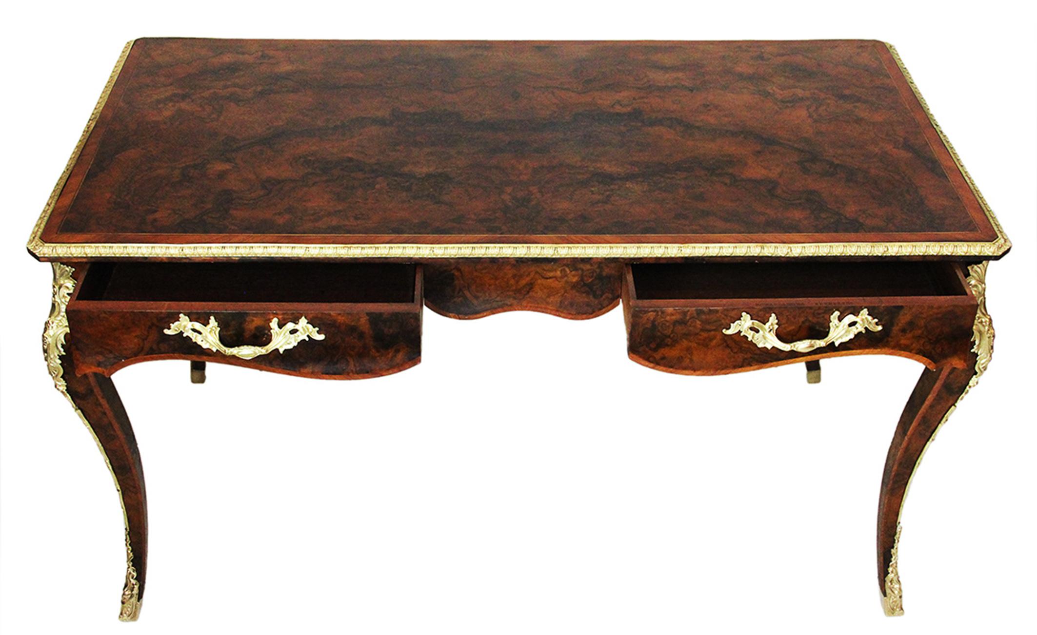 19th Century Howard & Sons Desk in burr walnut and gilt bronze ornaments :
Superb desk in burr walnut and rich ornaments of gilt bronze. Exceptional work of marquetry and veneer in burr walnut. Stamp of the famous English workshop Howard and Sons,
