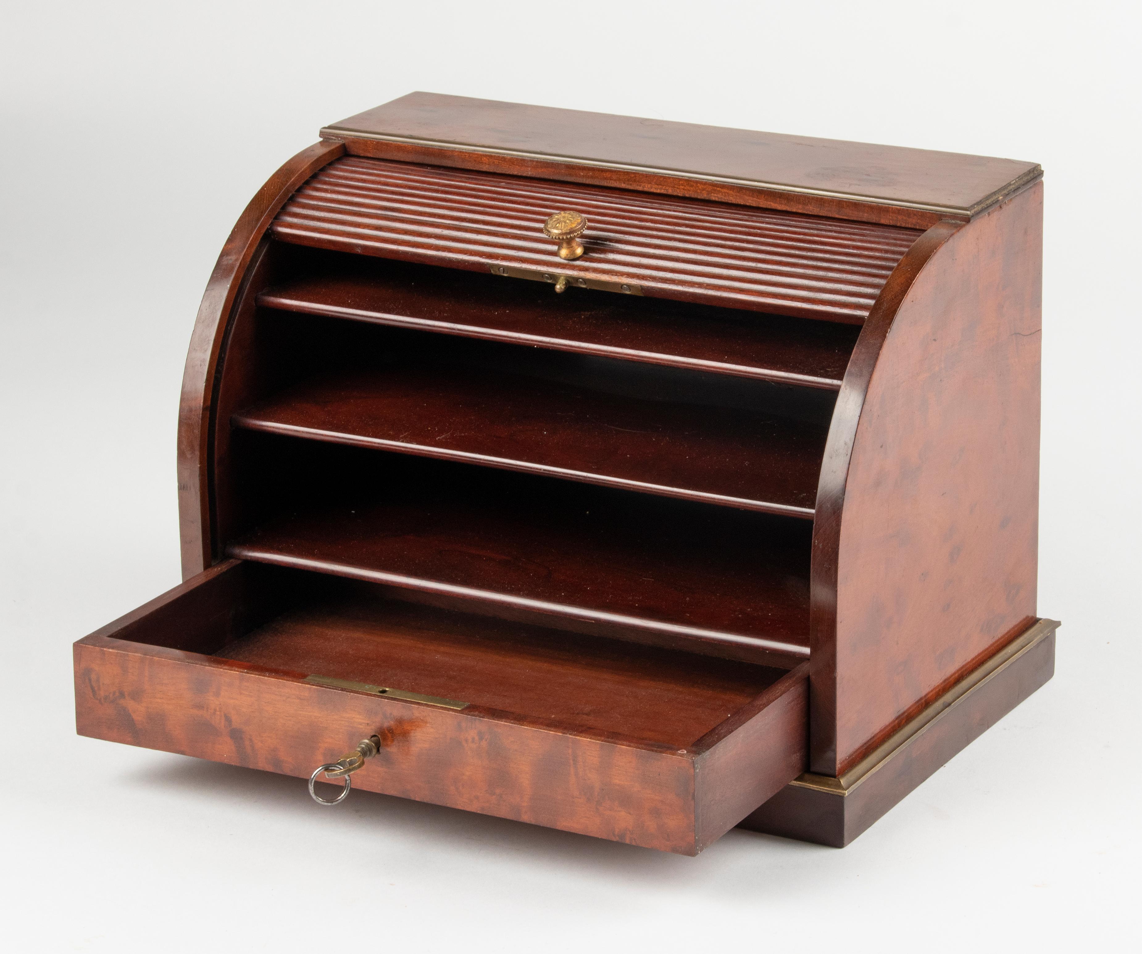 Beautiful antique box for letters / documents with a roller shutter door. The box is made of mahogany wood and above the foot is a bronze profiled frame. The box is in good condition, with working lock and original key.