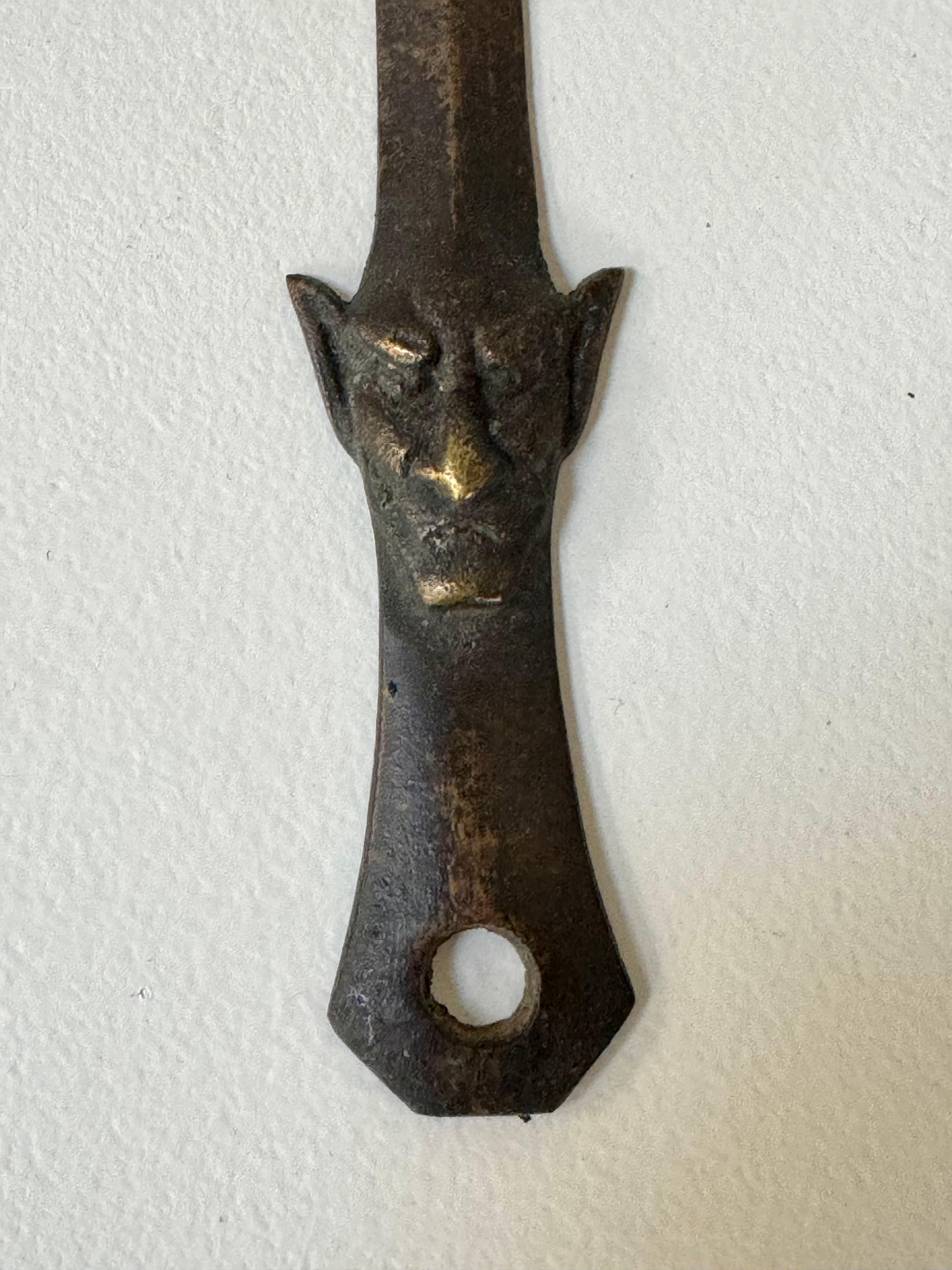 19th Century cast bronze devil letter opener, having a rich patina to the bronze with the Devil's face near the base of the handle, an unusual item.