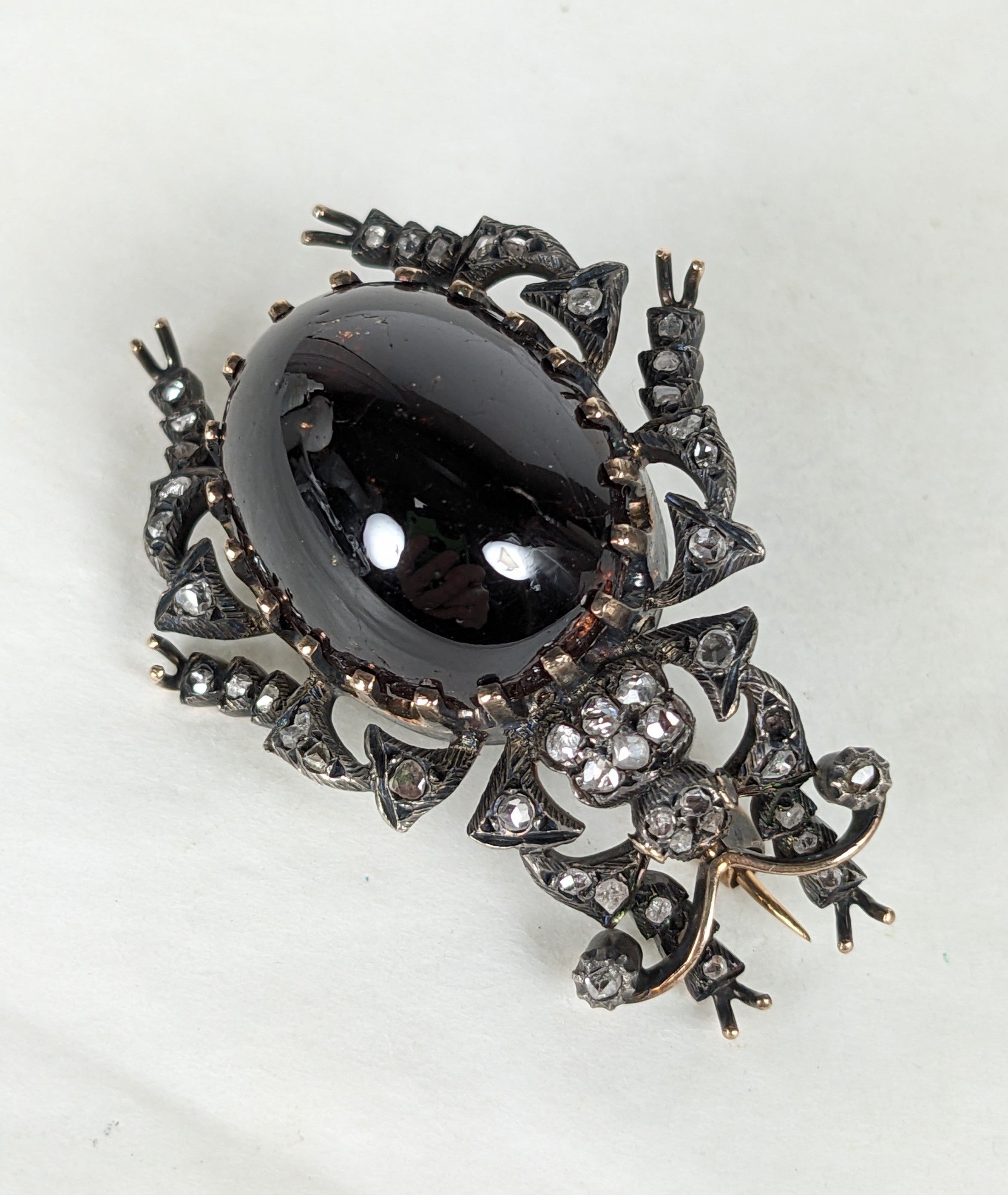 Lovely 19th Century Diamond and Carbuncle Garnet Beetle. Realistically modeled with large cabochon garnet set in high gold prongs with body elements all detailed in rose and rough cut diamonds. Set in silver topped gold as is customary for the 19th