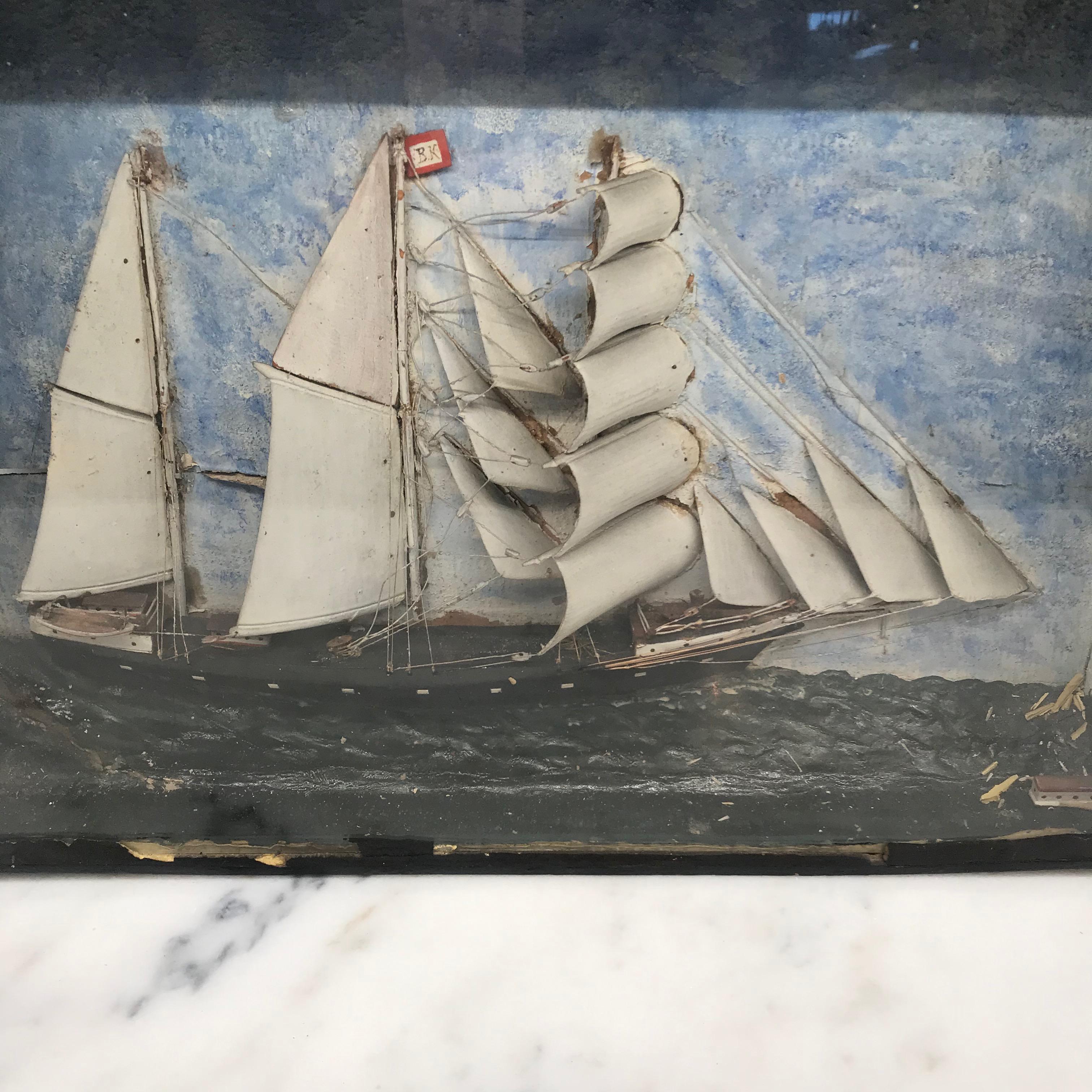 Early 19th century diorama of a three masted ship in full sail in a choppy sea of white-capped white waves amidst blue skies. In original framed glass shadow box.
#4293.

   