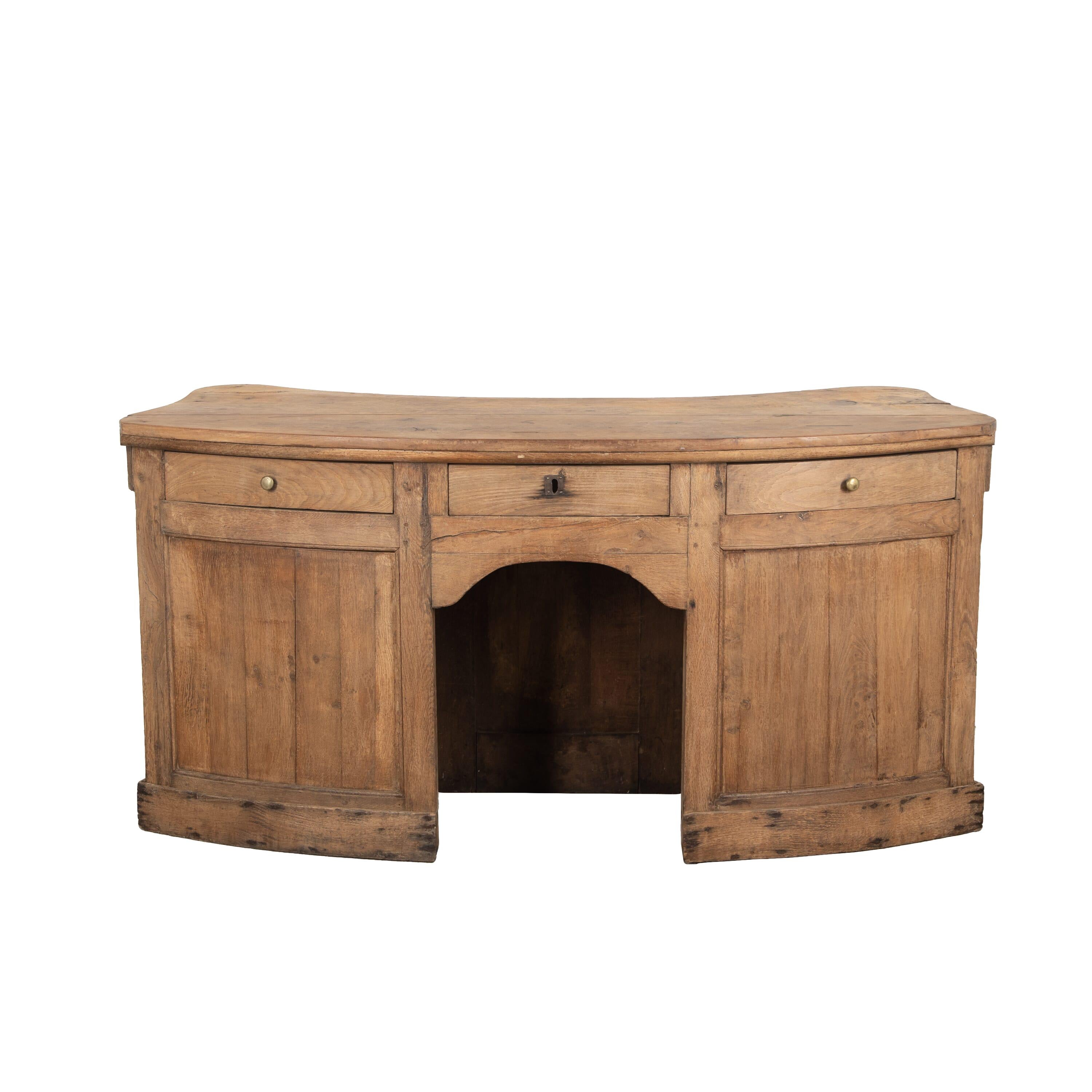 19th Century French oak shop counter.
With an exceptional curved shape with column detailing to the front. Behind three useful storage drawers and a space for a use as a desk.
circa 1840.