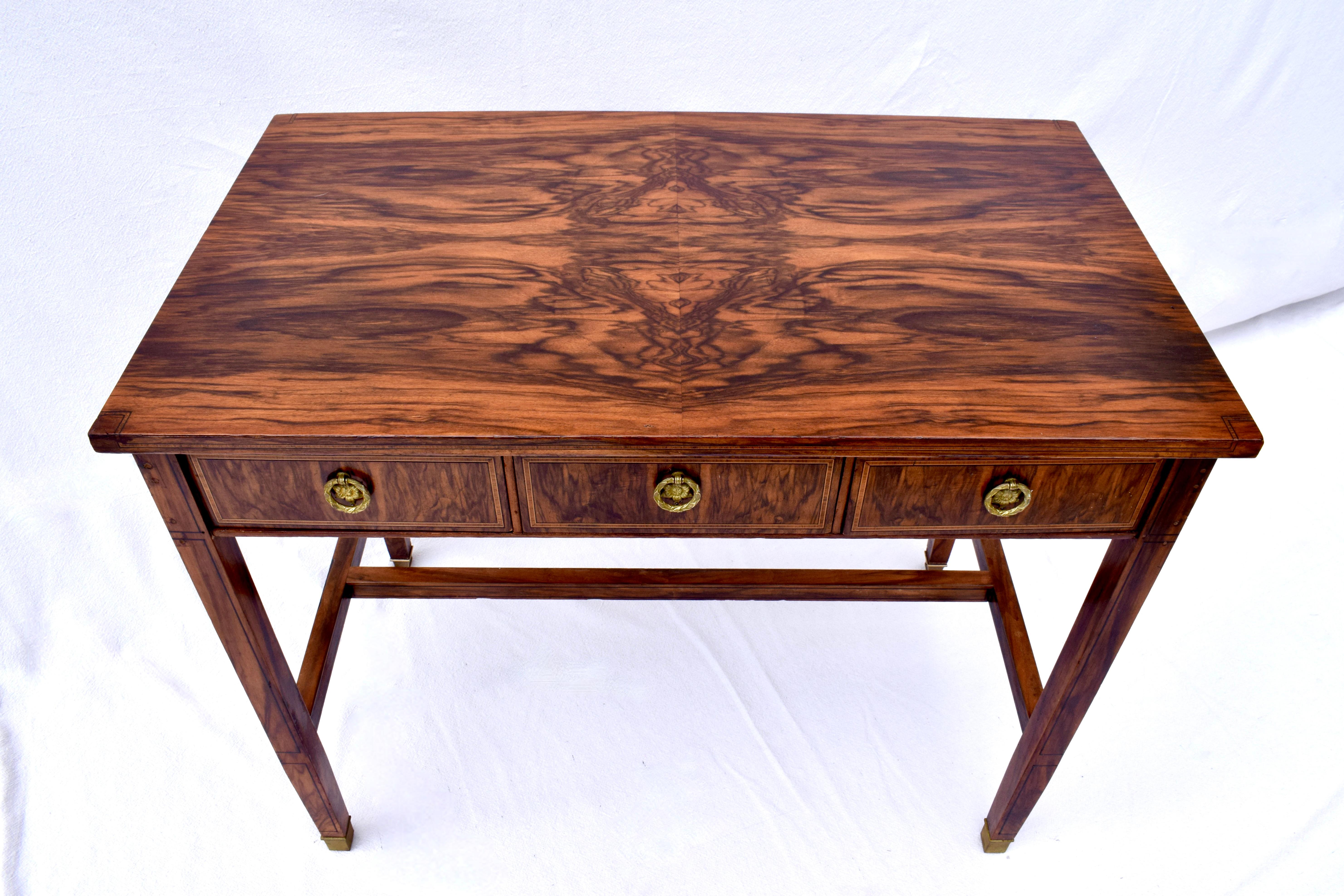 19th c. Rosewood writing desk or work table of impressive book matched fiery grains, original Directoire style brass pulls with inlay details throughout the entire piece. A striking table well suited for purposeful & aesthetically pleasing placement