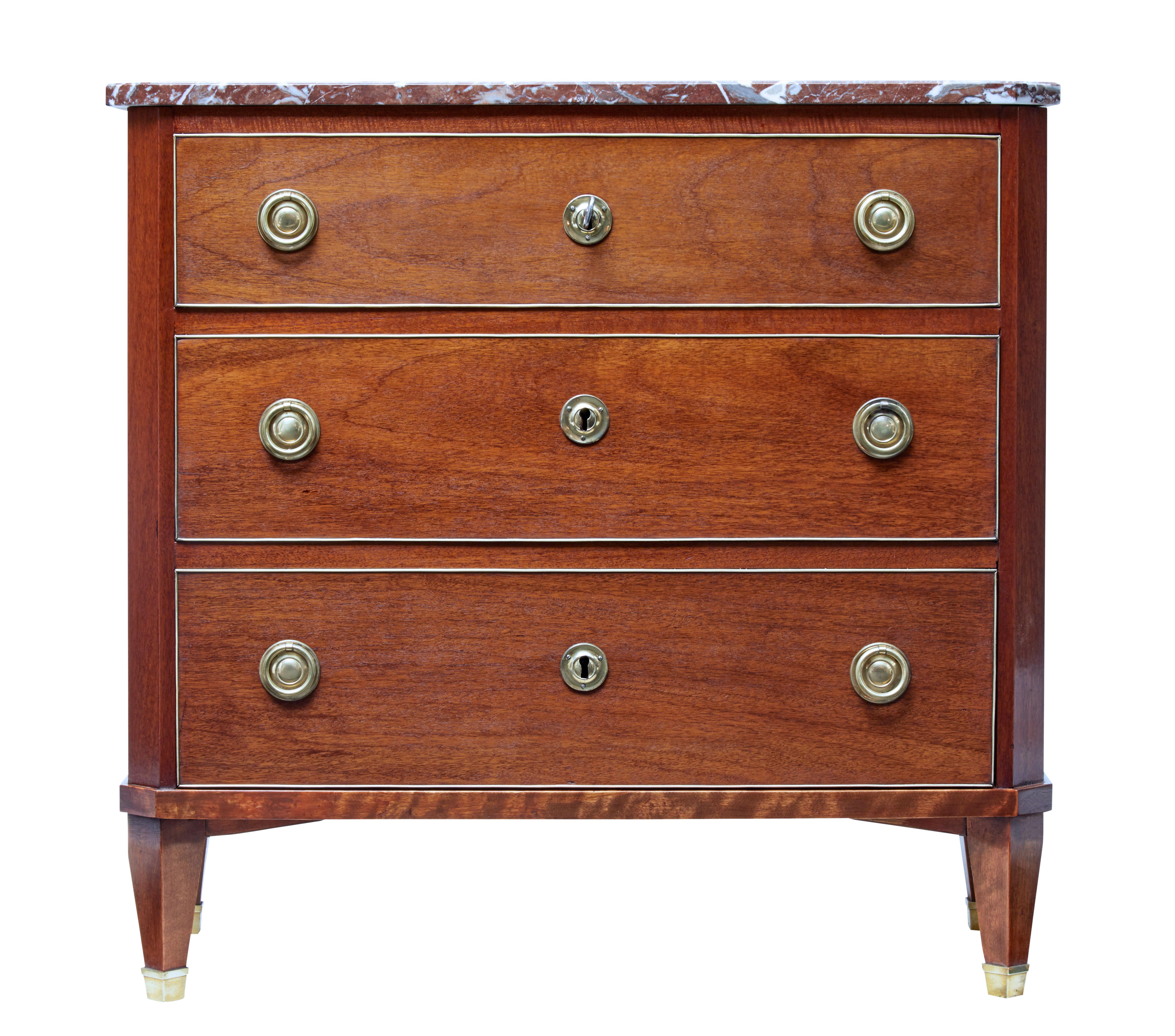 Elegant 19th century chest of drawers in the Directoire taste, circa 1880.

3 brass edged drawers with brass ring handles and escutheons.

Original marble top, which can be glued into place if desired.

Standing on tapered legs with brass