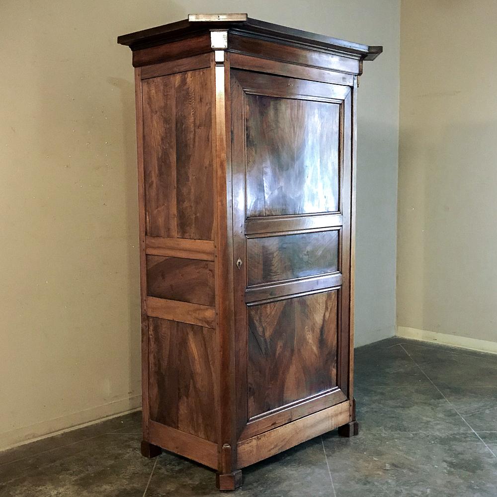 19th century Directoire period walnut Bonnetiere is a Classic example of rural artisans copying the style dictates of the royal court during their lifetimes. Old growth, exquisitely grained French walnut was carefully hand-picked then bookmatched to