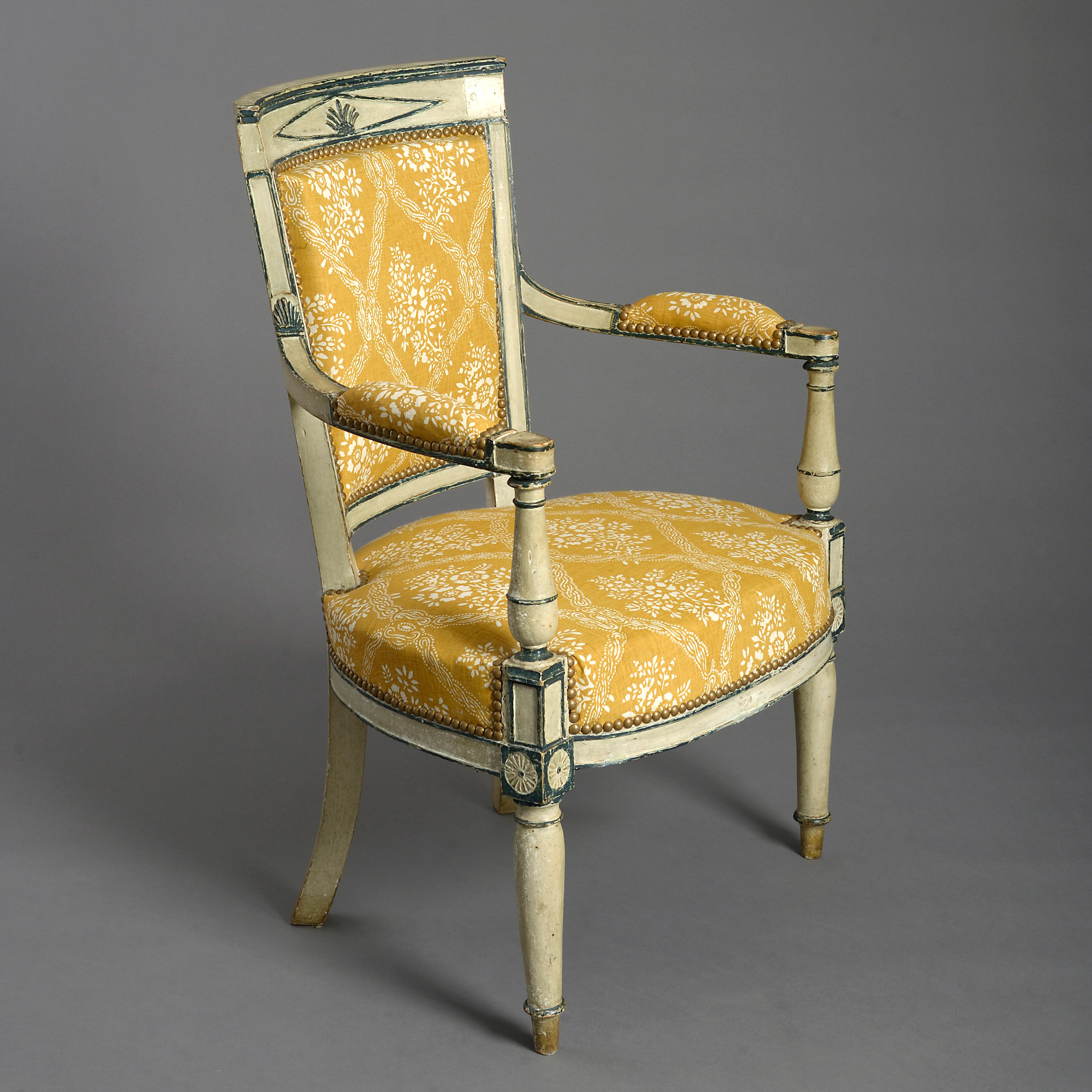 A charming late 19th century blue and white painted open armchair in the Directoire manner, the square tapering upholstered back with swooping arms, set upon turned supports, the upholstered seat raised upon turned tapering legs, headed with