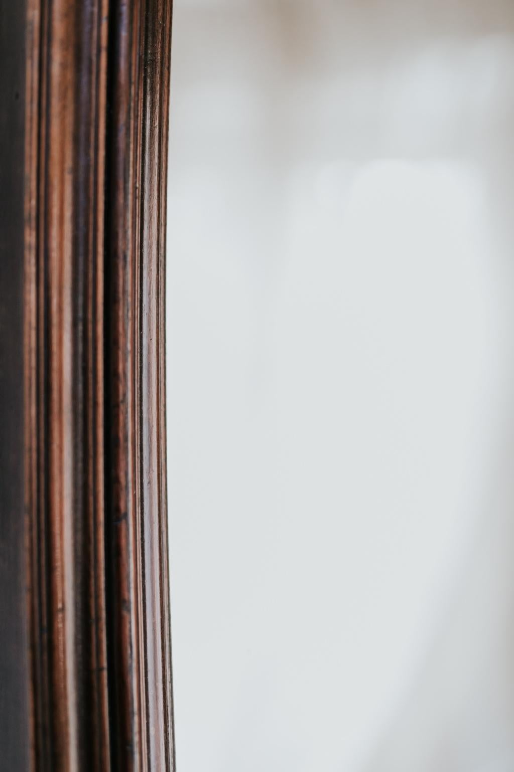 An unusual and very chic distortion mirror, with beautiful walnut wooden frame.