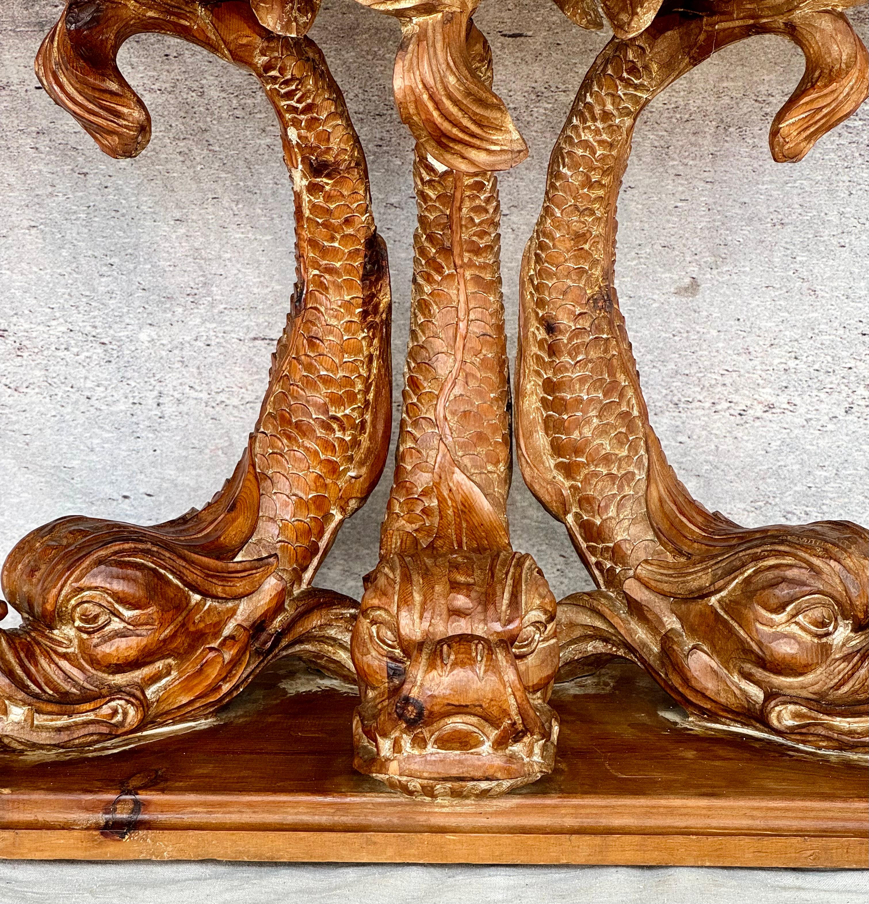 Wonderful classic Dolphin Form Carved Pine Console Table. The molded edge single board demi-lune top, with triple carved dolphin supports, on an integrated molded canted base. Extremely fine carved details and a nice natural pine with a soft washed