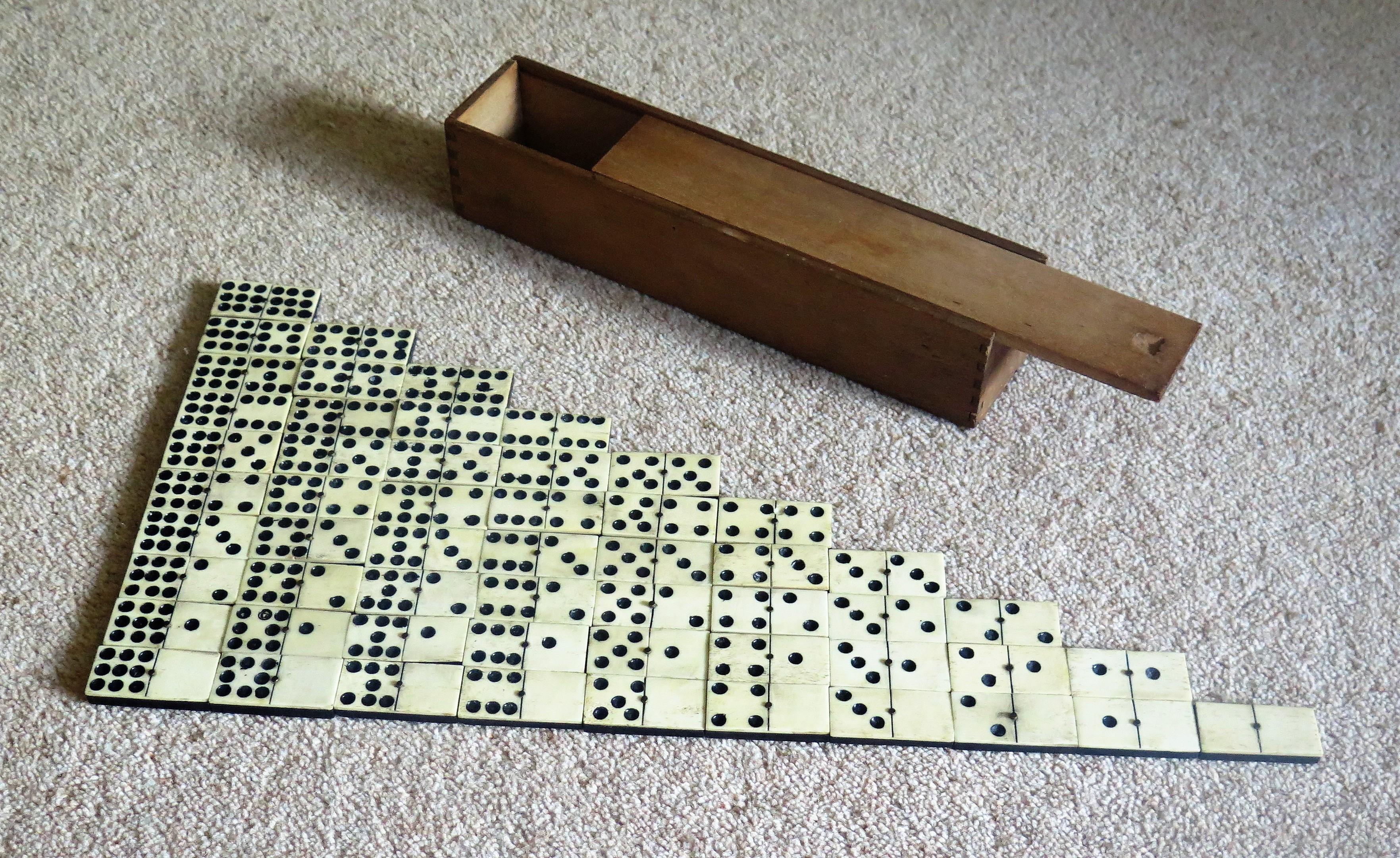 This is a rare, original and complete '9 Spot' dominoe game set of 55 individual dominoes, coming with its own jointed wooden box or case.

Dominoe sets are normally six-spot sets giving a total of 28 dominoes.
This set is much rarer, having a