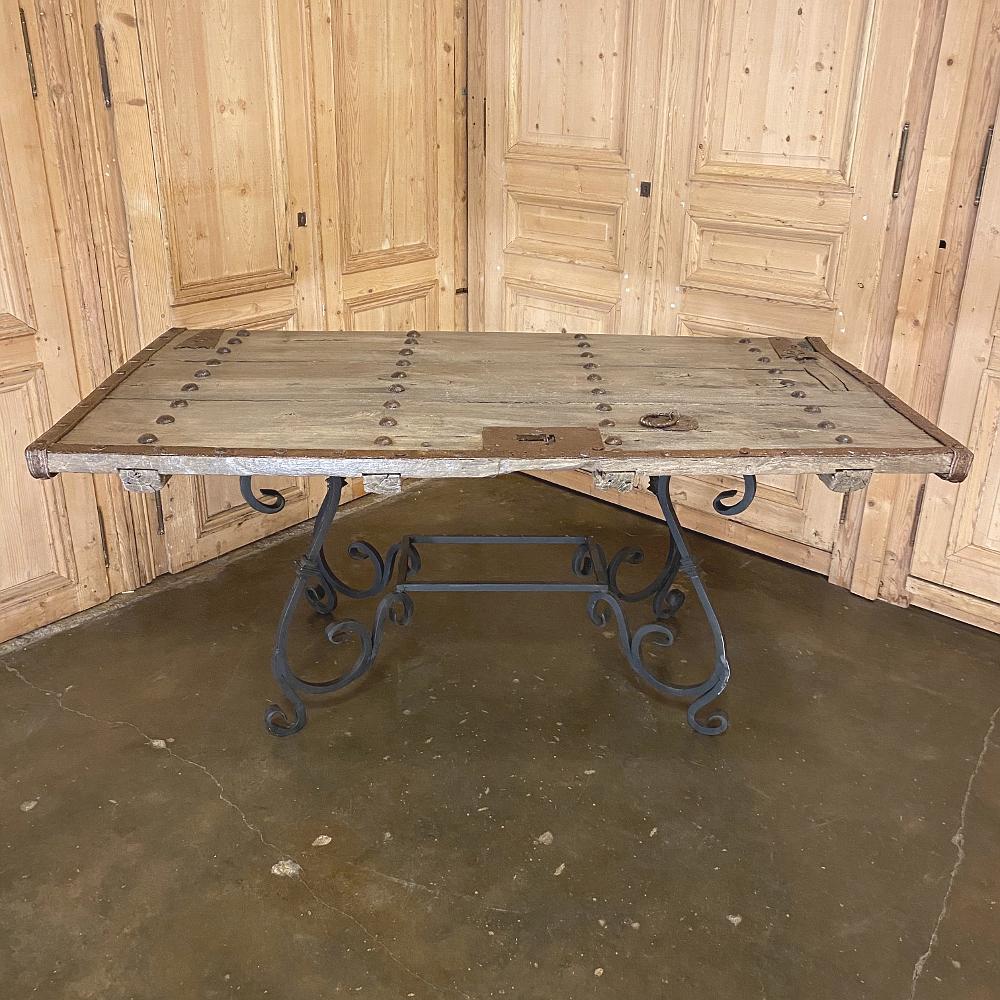 19th century door converted to wrought iron dining table represents a clever 
