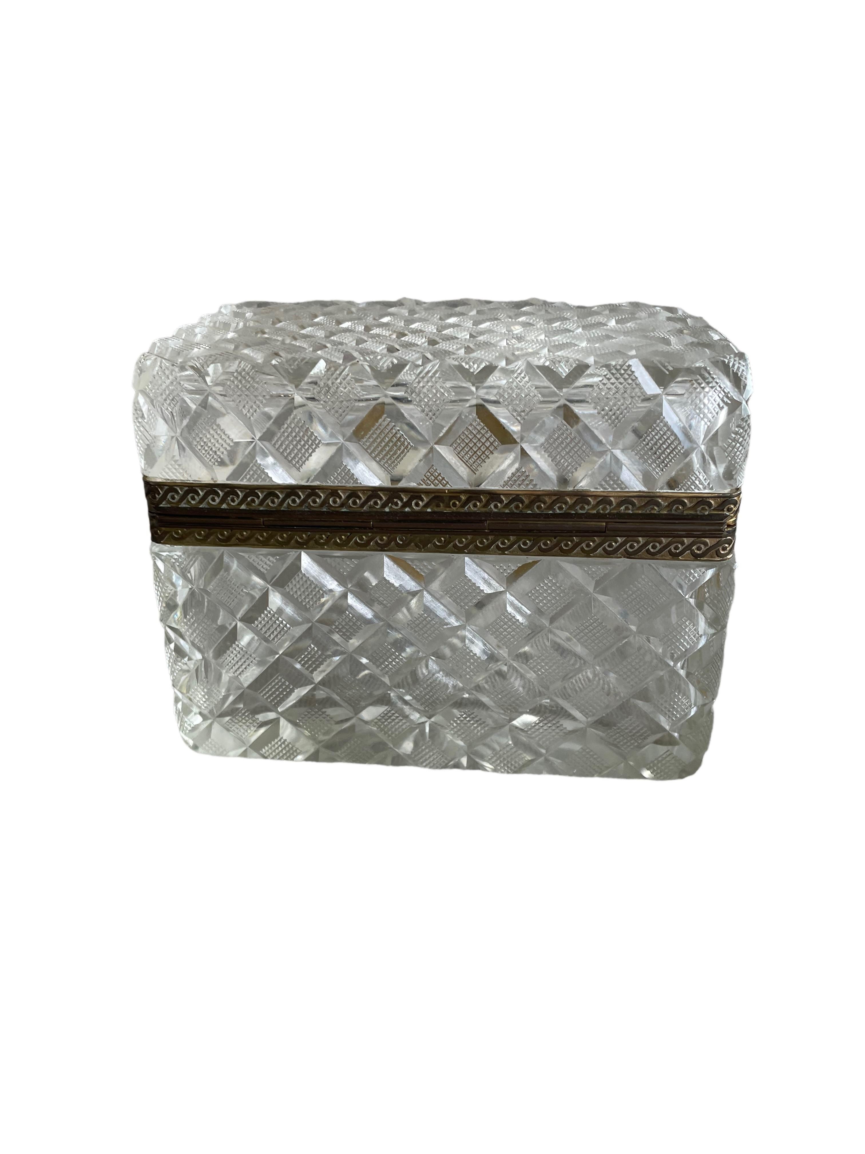 This antique crystal box is a true gem. The cut crystal is mesmerizing, due to its hand-chiseled facets that catch the light reflecting it in a thousand dazzling ways. The antique appeal of this box is further heightened by its detailed Dore Bronze