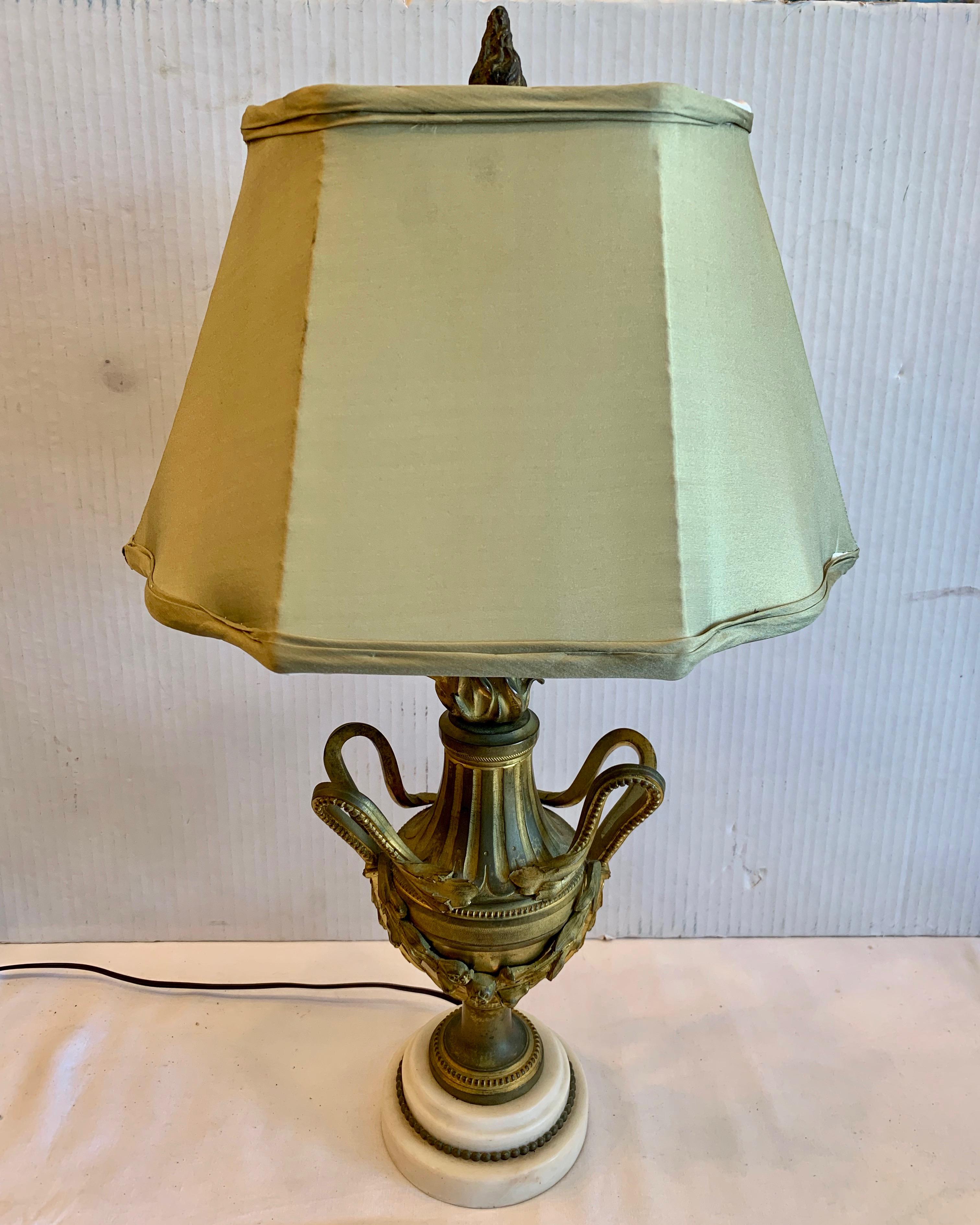 A fine bronze urn with a stepped up marble base, now electrified.
An excellent desk top or night stand, or accent piece . The urn with marble
base is 12