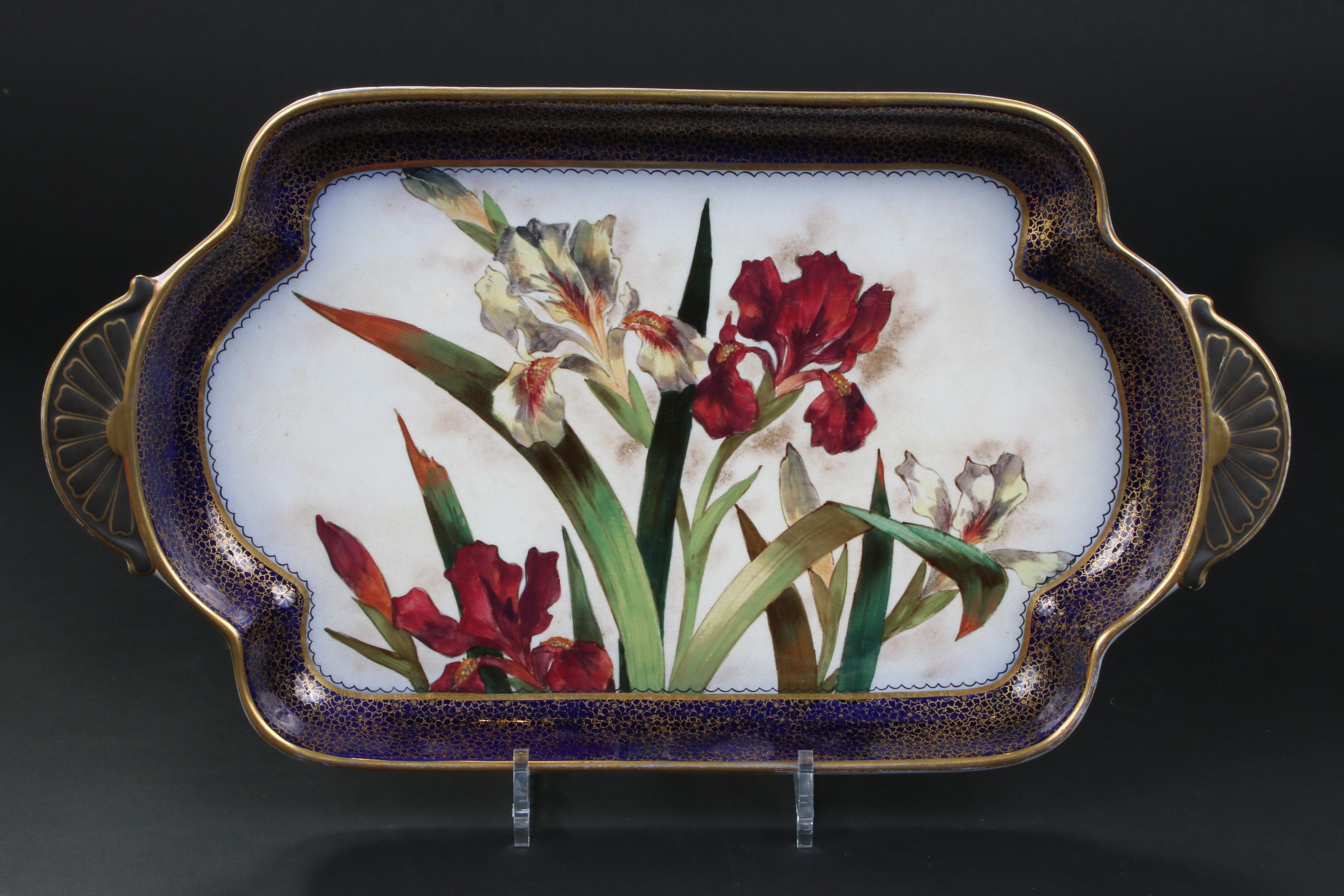 Lovely Doulton Burslem, England, hand painted dessert set: 1 rectangular tray and 8 small square plates. Depicts red and white irises and primroses, surrounded by a cobalt blue and gold border. Each item is hand painted with a different design. This