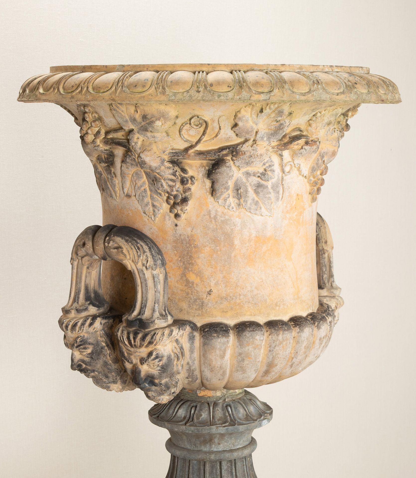 A fine and extremely large, late 19th Century English Country House terracotta centrepiece garden urn on pedestal.By Doulton of Lambeth. Of campana form, with fine egg and dart rim and vine leaf border, above bold masked handles, the urn standing on