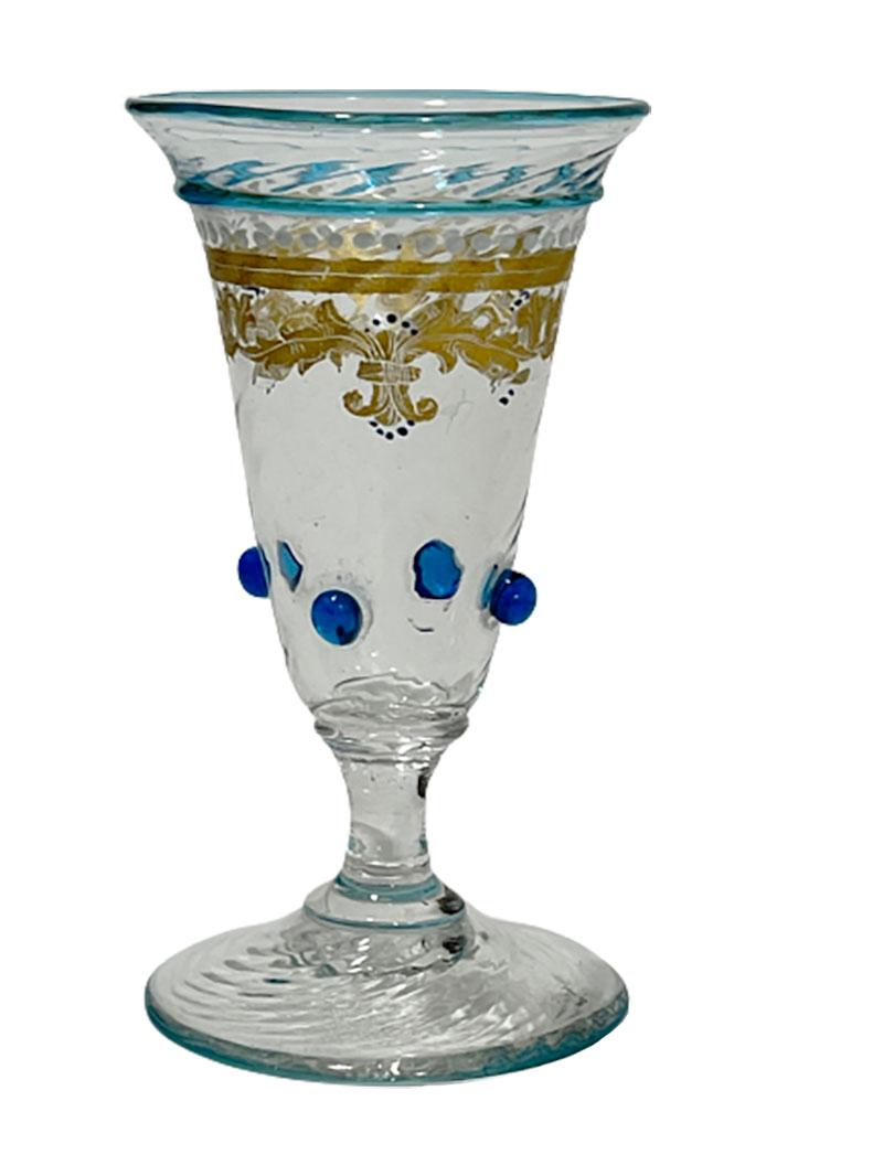 19th century dr. Antonio Salviati liqueur glasses

7 pieces of clear swirl glasses with Azure blue line and dots on the glass. In between the blue has the glass gold paint and white enameled dots.
Salviati, Dr. Antonio Company (1859-1987) Italy,