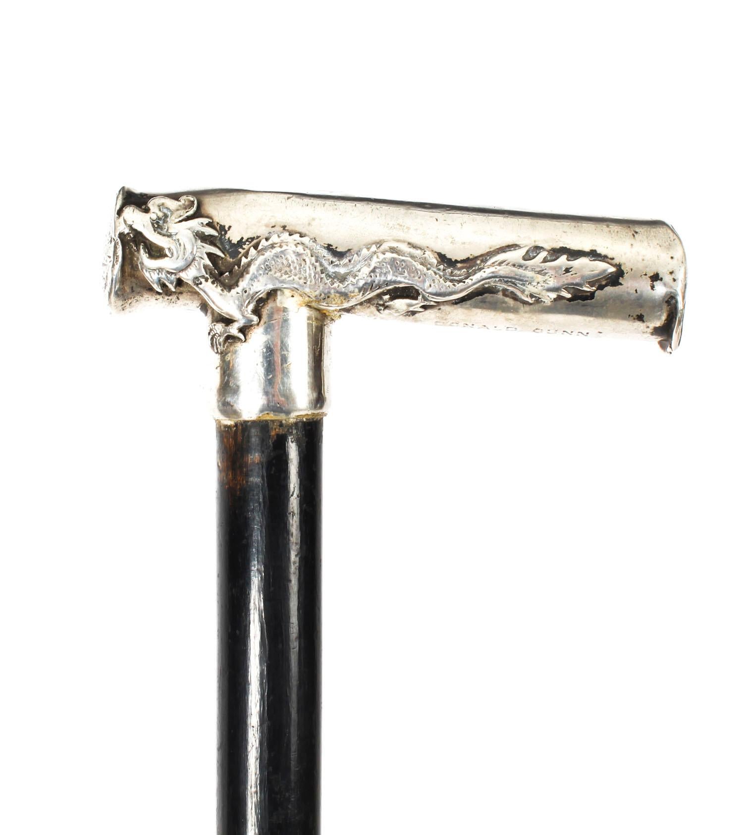 This beautiful antique Chinese silver mounted ebonized walking stick is circa 1880 in date.

It has an exquisite Chinese silver L-shaped handle decorated with a pair of dragons. The ebonized shaft is complete with its original bronze ferrule.
