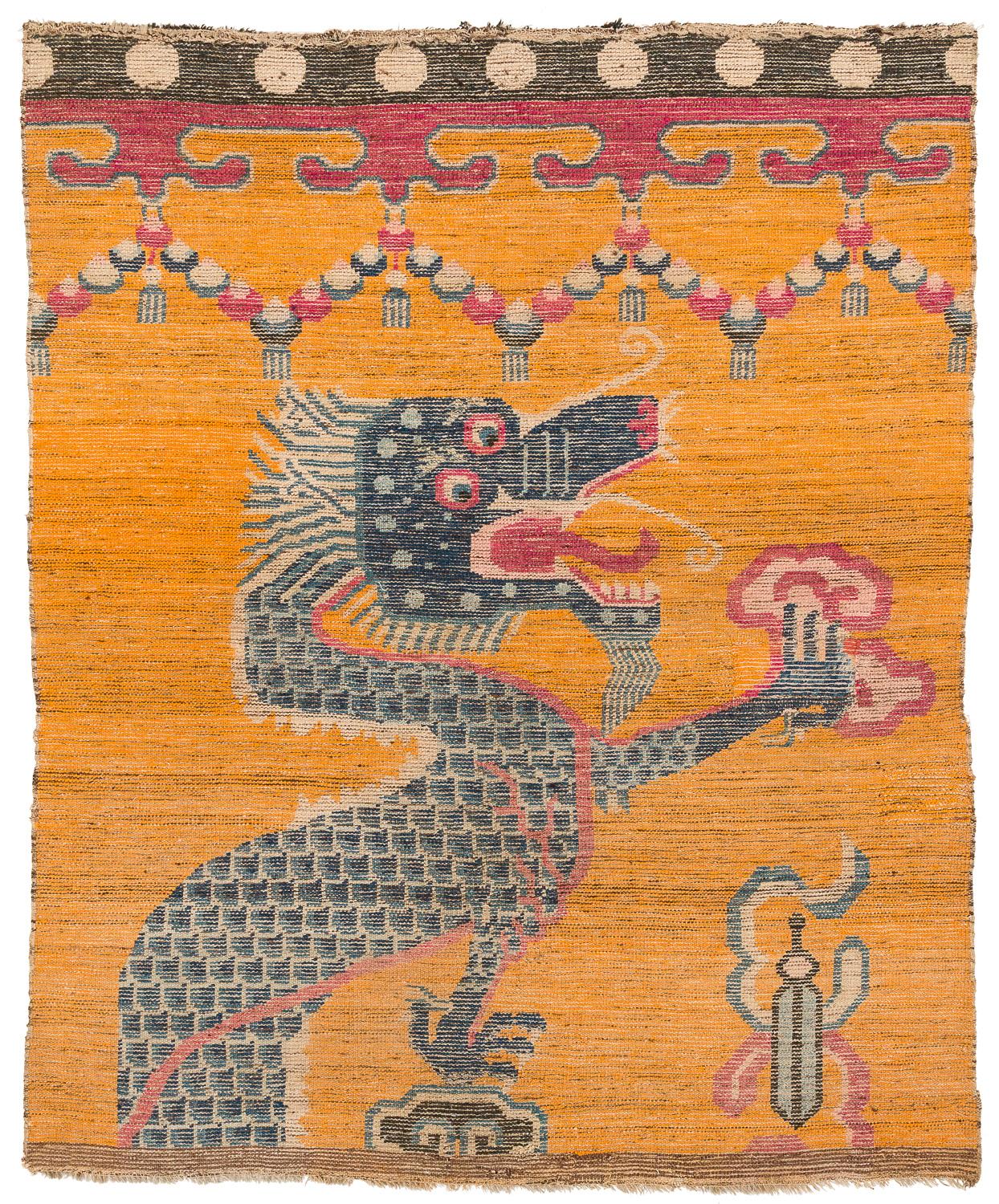 A rare antique orange Chinese Tibetan dragon rug likely from a Tibetan monastery. The ornamentation along the top imitates a curtain or a skirt, which indicates it was a pillar rug, wall hanging or tapestry.

A powerful design with unusual, vibrant