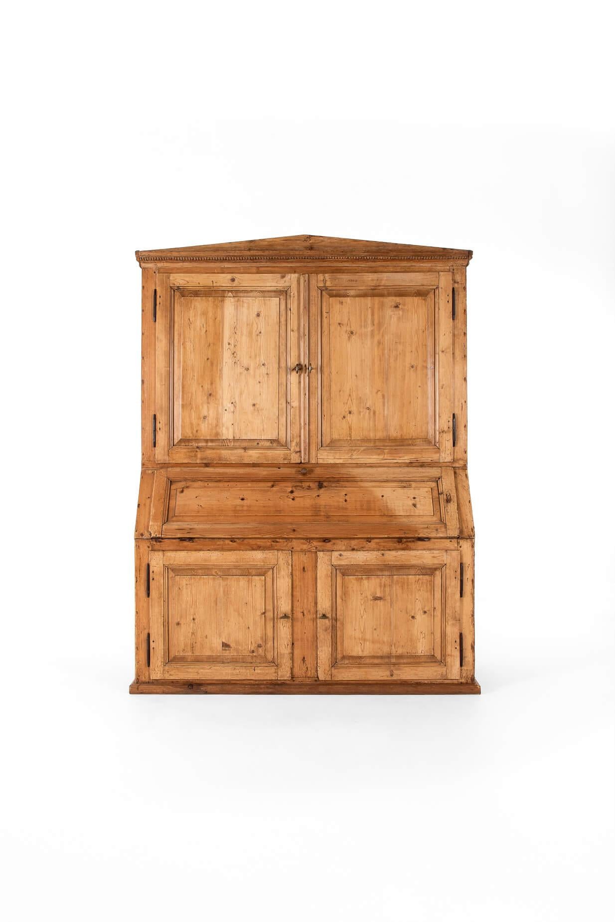 A striking 19th-century pine dresser with an unusual central secretaire.

The top pair of cupboards open to reveal two generous shelves, ideal for books or kitchenalia, with a decorative triangular cornice surround.

The central bureau or secretaire