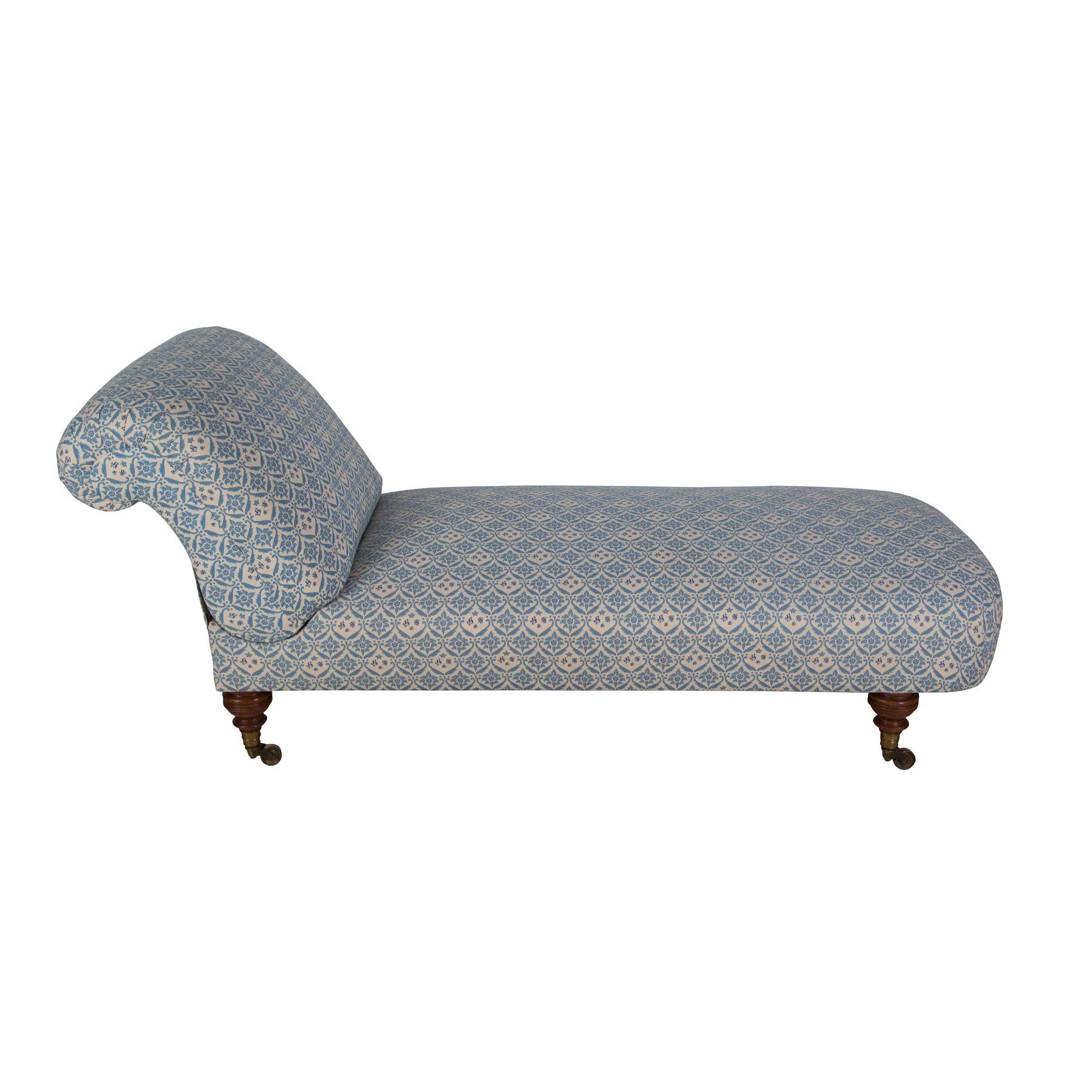 An exceptional and rare Howard & Sons drop back daybed, restored and upholstered in H&S blue ticking, raised on finely turned walnut tapered legs with original stamped castors and one leg stamped with the 7 digit identification number (64116684)