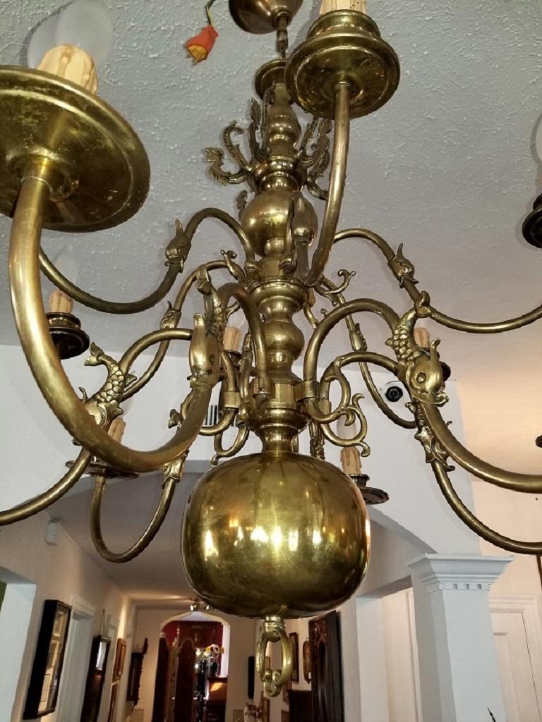 Stunning Dutch Baroque brass chandelier ……..12 branches in two tiers.

Fully re-wired.

From circa 1870-1890.

Double Eagle top with several sections and 12 branches on 2 tiers….6 on each tier.

Mermaids on top level with fish on the mid