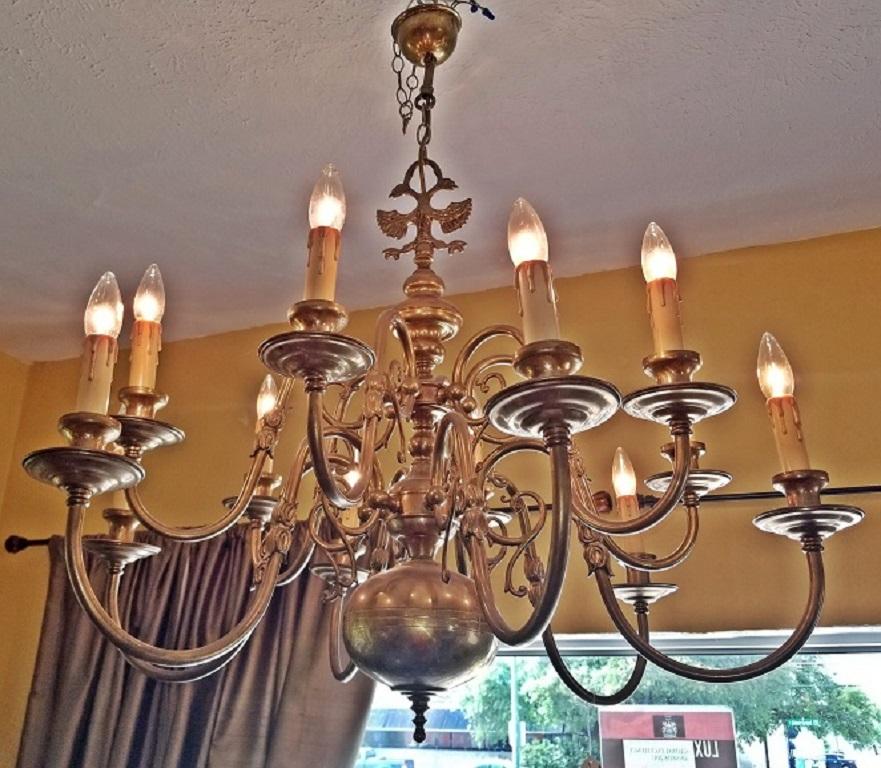 Beautiful Dutch Baroque brass chandelier-large size.

Two-tier chandelier.

12 Branches with turned arms. Each arm or branch is decorated with a double tulip.

Each branch ends with candle holder sockets.

The Chandelier ends with large ball and