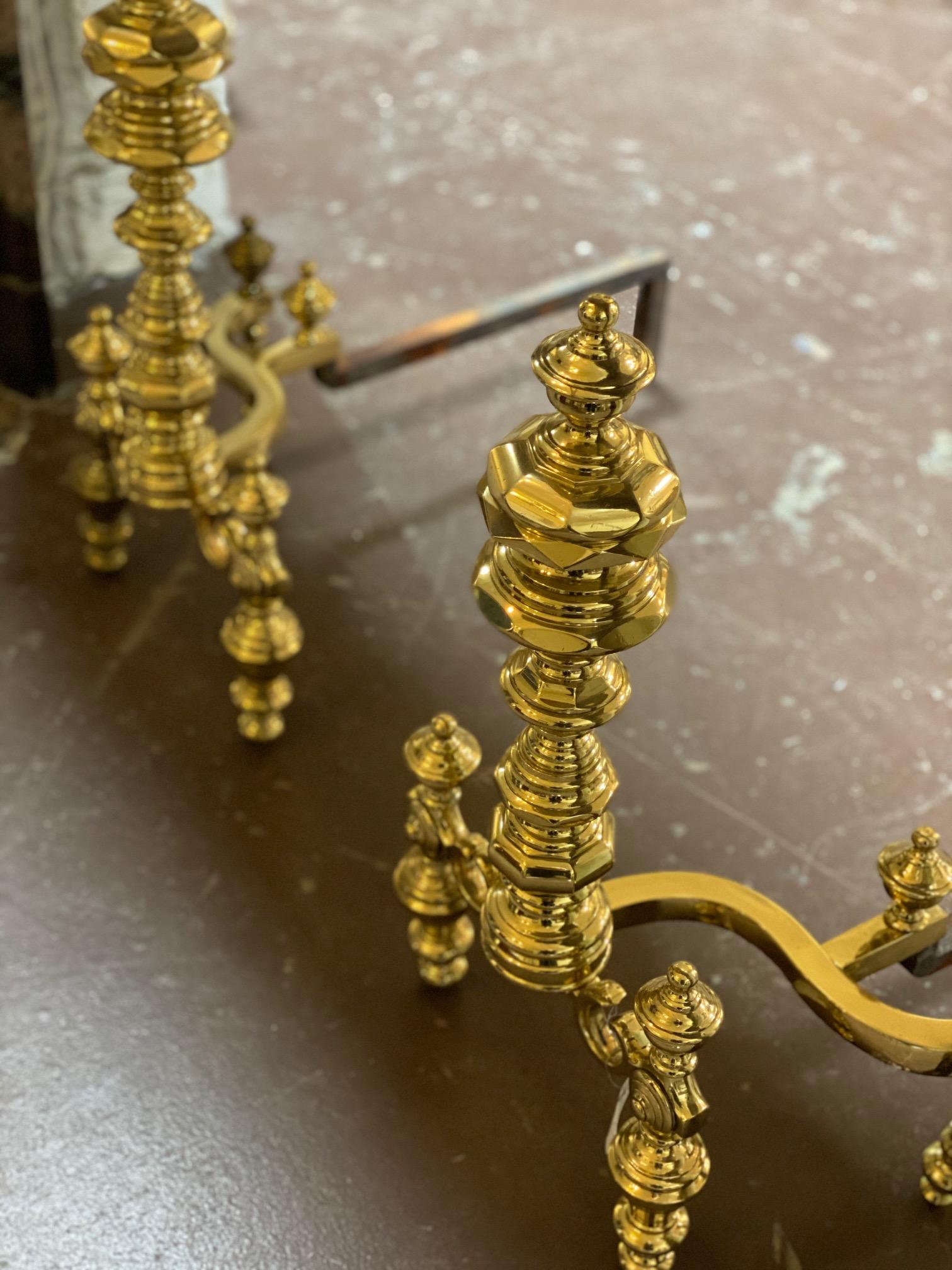 Pair of Dutch Baroque style andirons, made of polished bronze and wrought iron. 

These antique bronze-fronted French Chenets (andirons) have a lovely reflective polished patina. Andirons, Chenets, fire-dogs, moon idols, moon horns, are just some