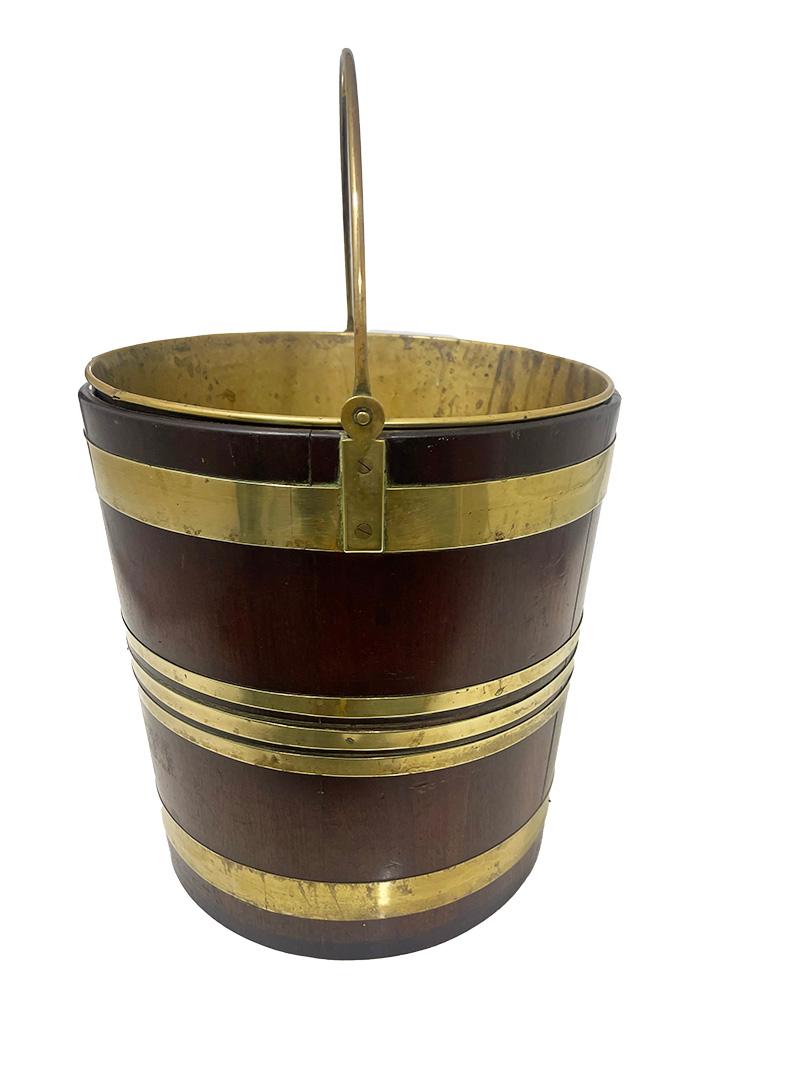 19th Century Dutch brass bound water bucket

a Dutch 19th century wooden water bucket. This bucket is made of wood in vertical strips bound with copper bands and these are nailed. Inside the bucket is a copper lining. This mahogany bucket with brass