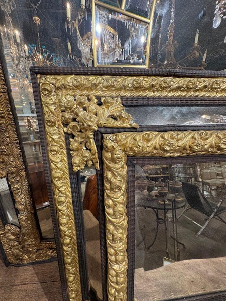 Découvrez l'élégance du XIXe siècle avec cet exquis miroir hollandais en laiton repoussé et coussin d'ébène. Les détails complexes en laiton mettent en valeur le savoir-faire de l'époque, tandis que les riches détails en ébène foncé apportent une