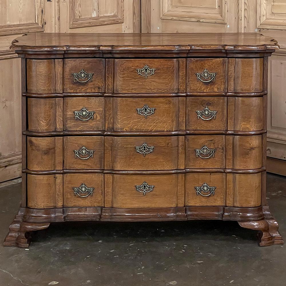 19th century Dutch Colonial chest of drawers is a handsome combination of understated elegance and pure functionality! Hand-crafted by master artisans from old growth oak and hand-cast bronze, it features an intricately scrolled and beveled top