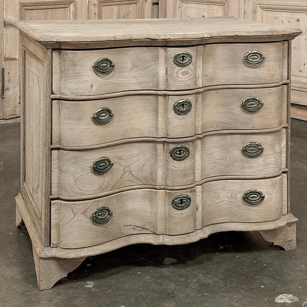 19th Century Dutch Colonial Stripped Oak Chest of Drawers features a tailored, no frills expression of the genre, perfect for the more casual decor.  A solid plank top merges with the caswork thanks to a tier of molding reversed from the sloped