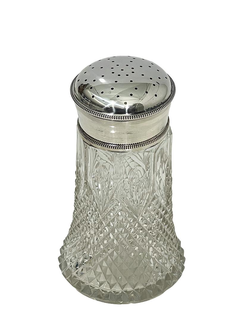 19th Century Dutch crystal with silver sugar or cacao sifter, 1890-1900

A Crystal sugar or cacao sifter with silver mounted top and lid. The crystal sifter has a diamond and fan crystal cut pattern. The silver is hallmarked with the Dutch silver