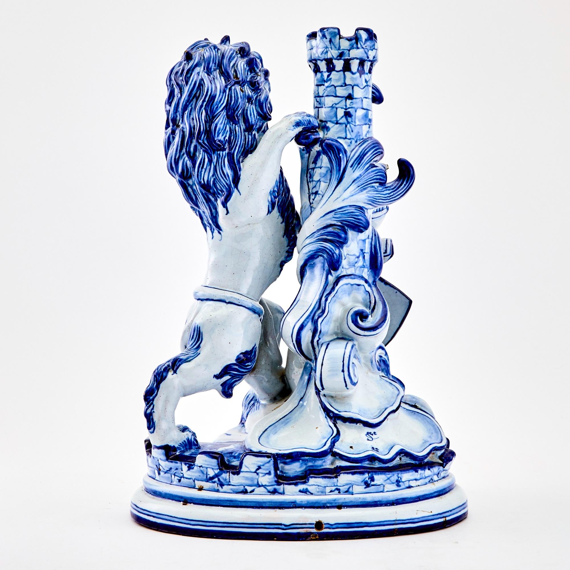 Transport yourself to the elegance of the early 19th century with this exceptional Dutch Delft sculpture—an enchanting portrayal of a lion proudly cradling a family shield crest. Crafted with meticulous artistry, the lion captivates with its