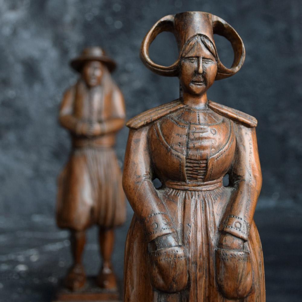 19th century Dutch Folk Art pair of hand carved figures 

We are proud to offer a true example of a pair of late 19th century hand carved Dutch folk art wooden figures. Each statue is hand carved with detail and aged patination across the