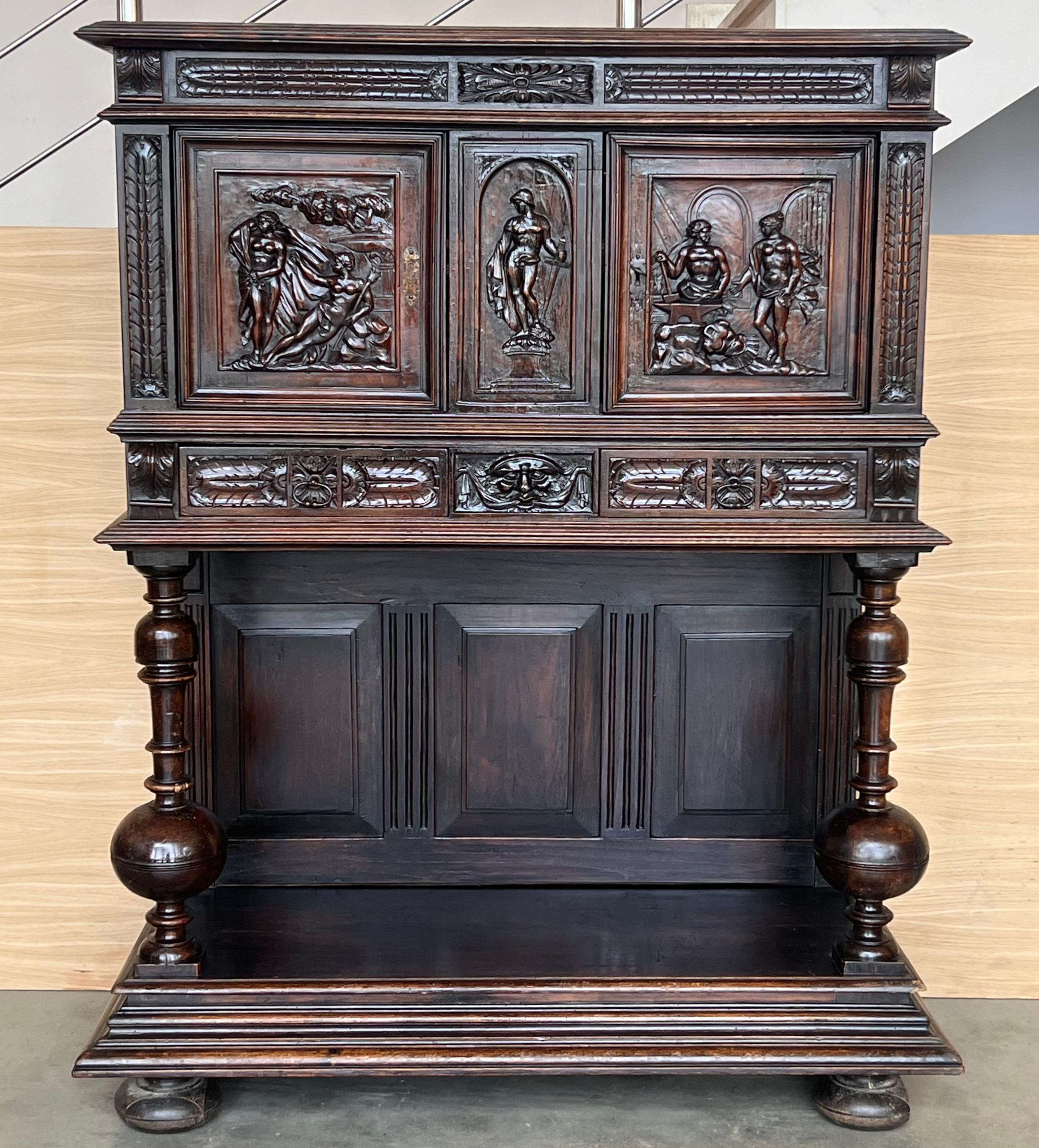 20th century Spanish hand carved Renaissance raised cabinet was rendered from dense, old-growth quarter sawn walnut, examples of which are on display in museums across Belgium and Holland that are over 1,000 years old! This stunning example features
